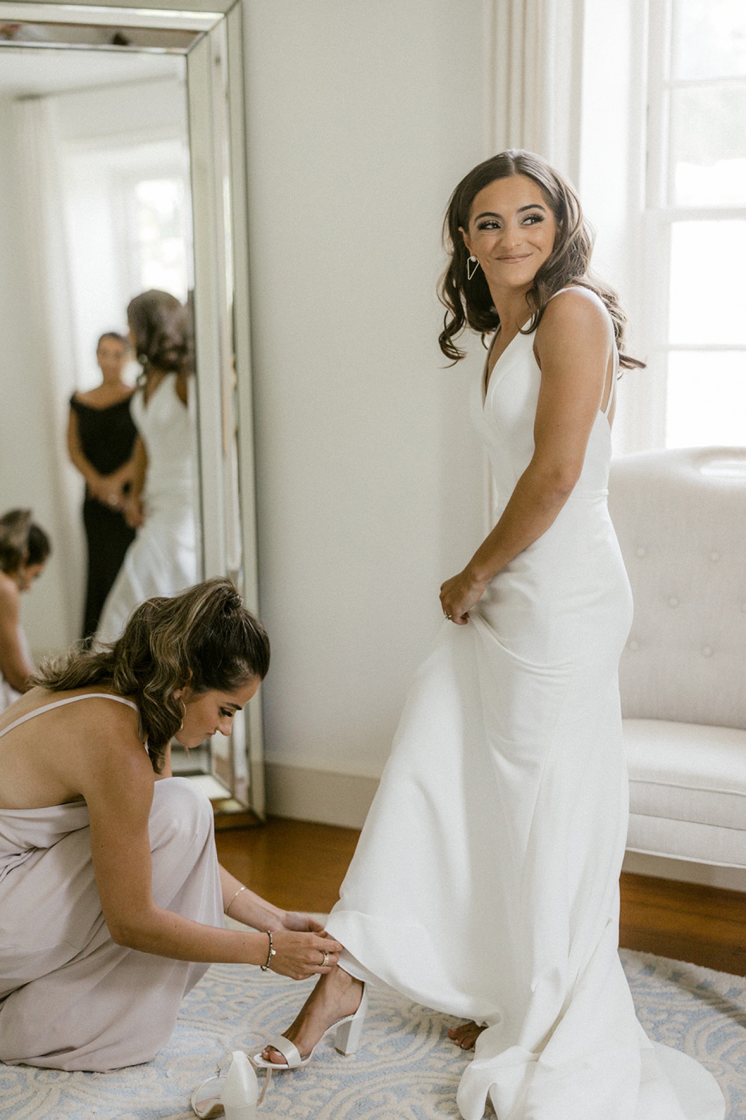 bride putting on shoes smiling