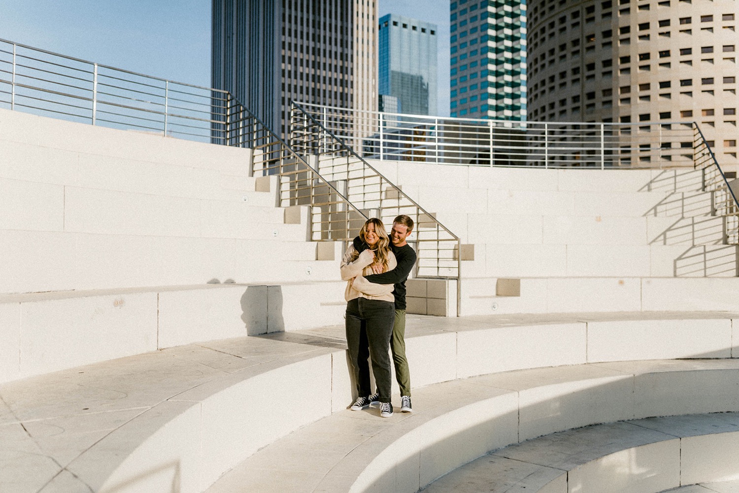 couple embracing on stairs in downtown tampa engagement session