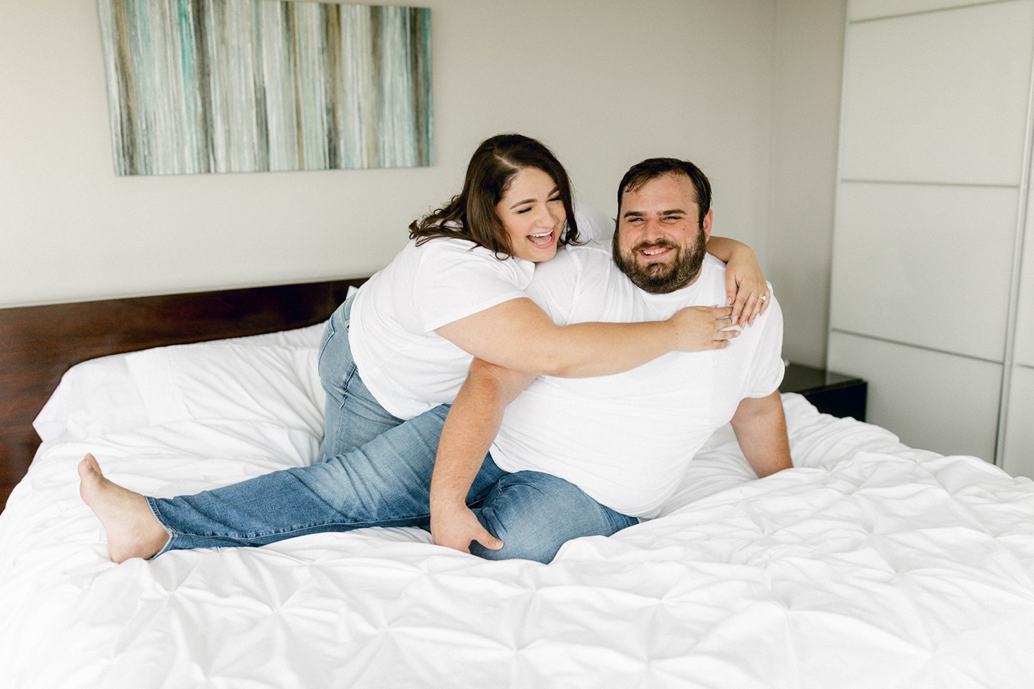 engagement session cuddling in bed