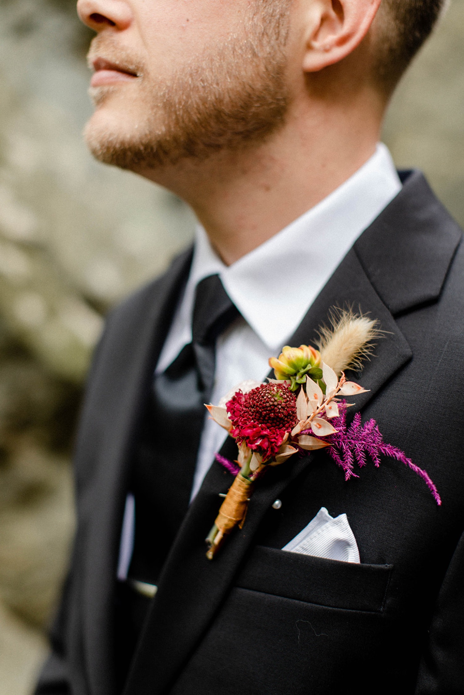 colorful bohemian wedding groom flowers
