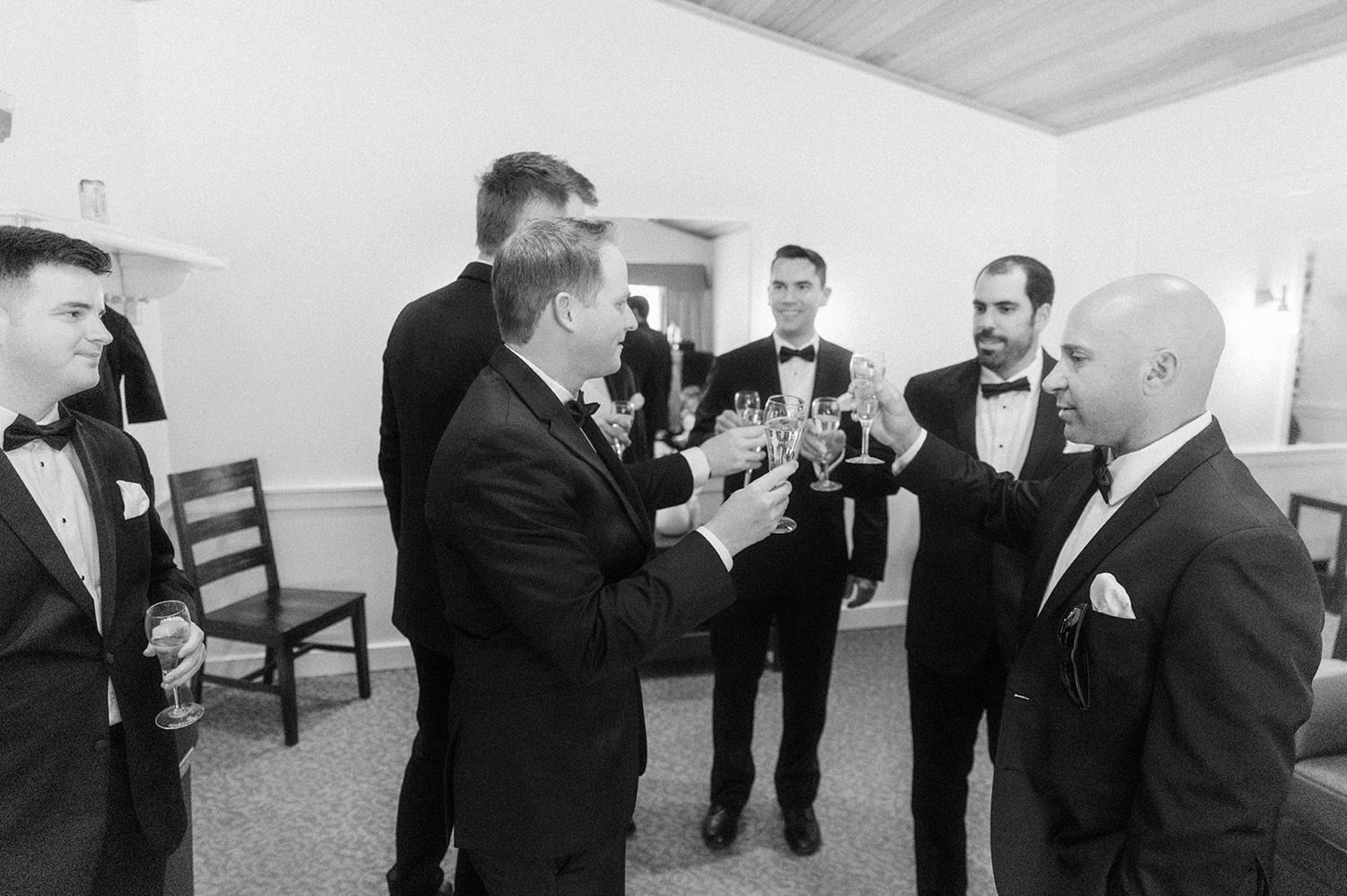 groom and groomsmen toast cheers getting ready