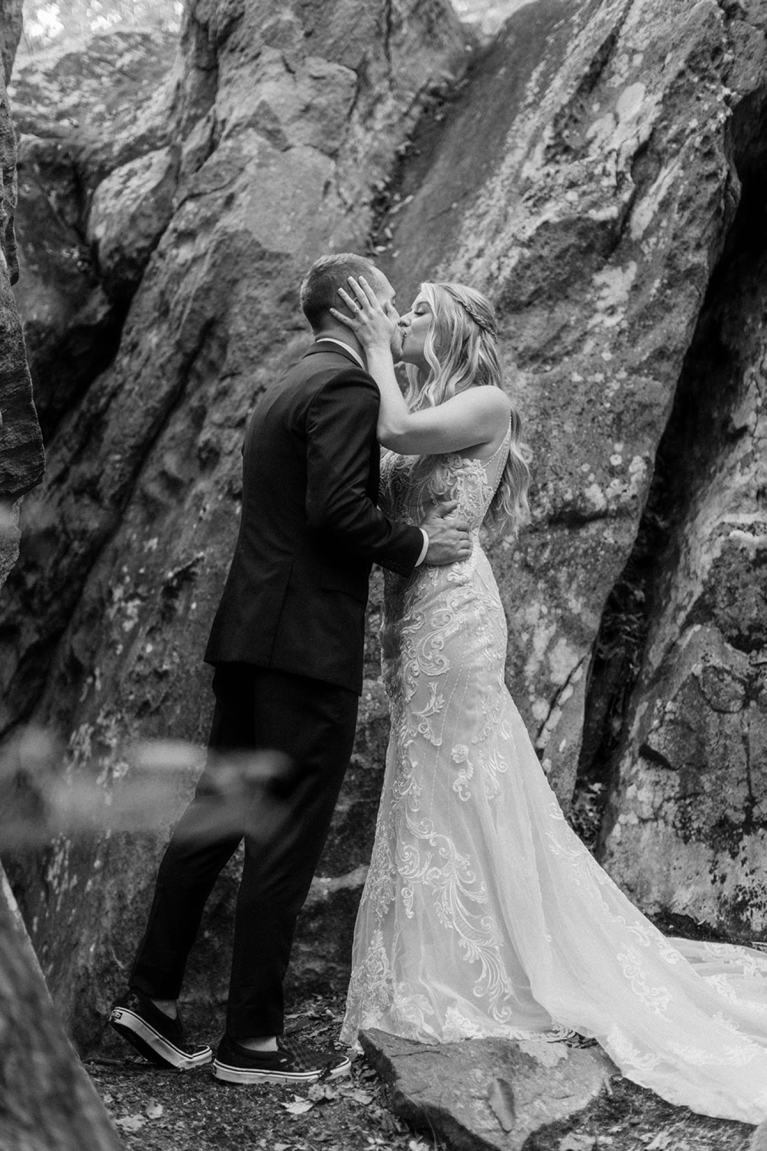 bride and groom kissing in the woods first look