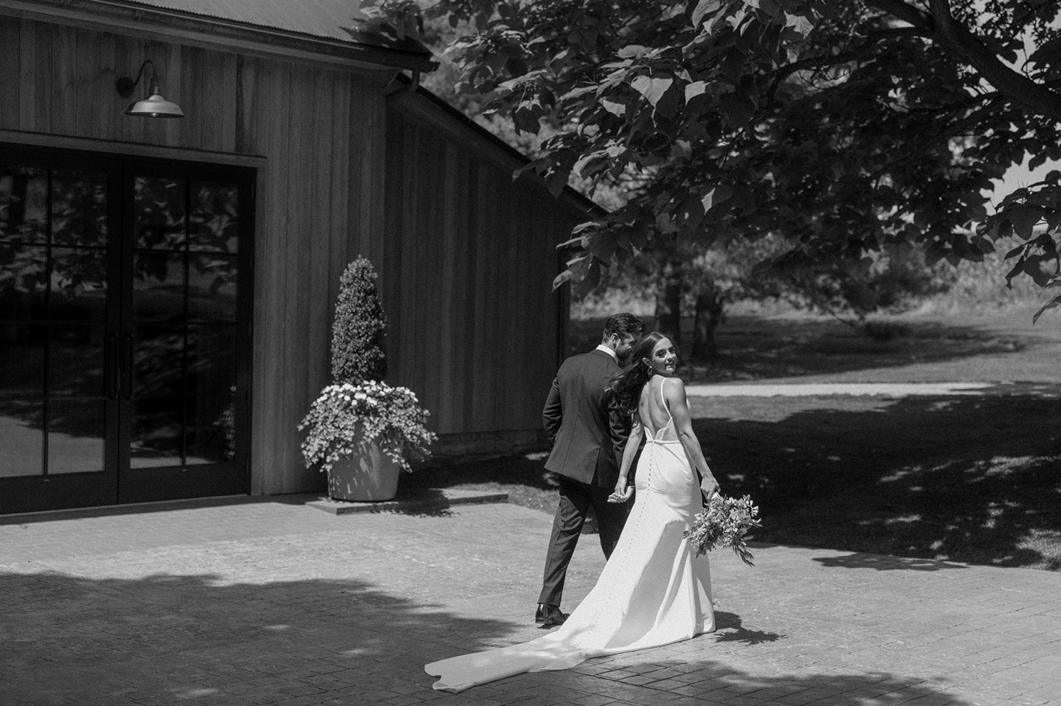 bride and groom walking looking over shoulder the farm at eagles ridge