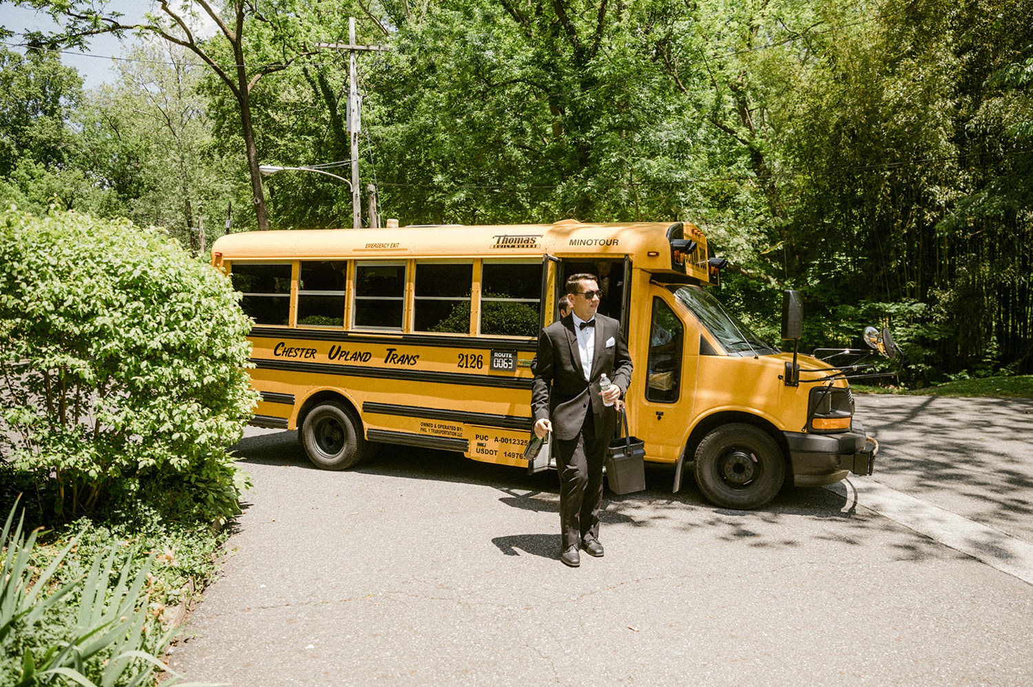 groomsmen arriving to wedding in school bus