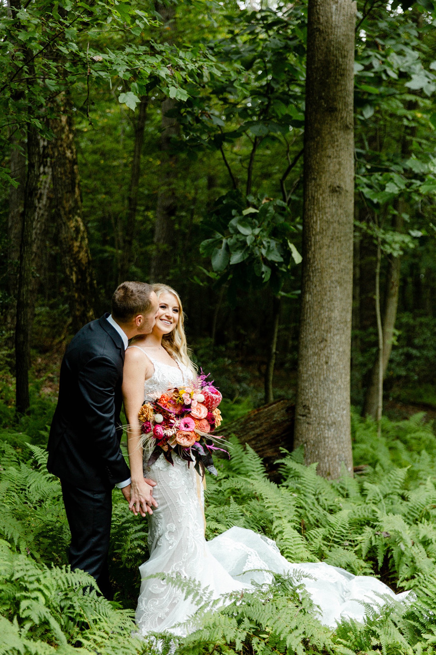 couples portrait in green forest bohemian backyard wedding