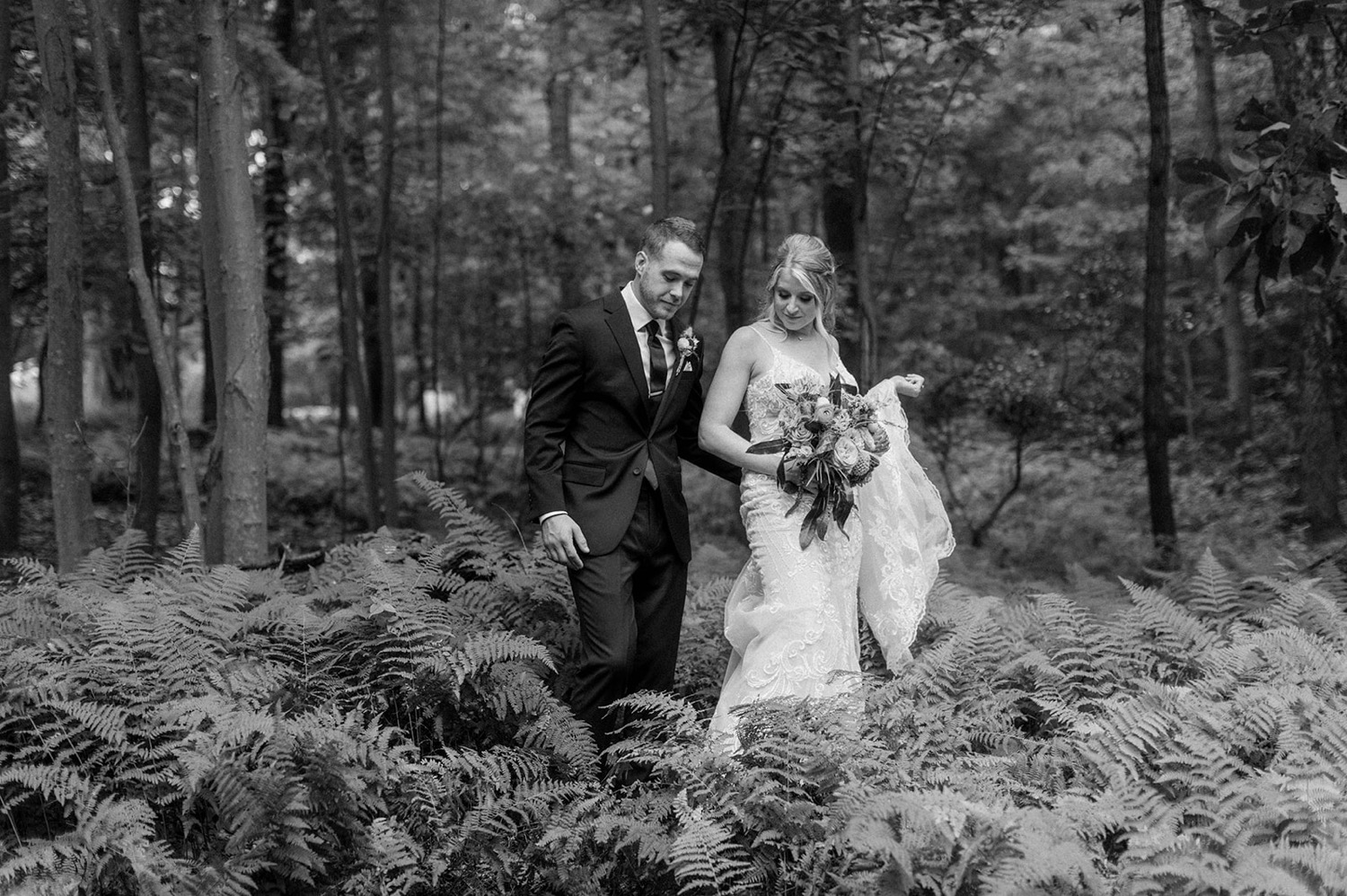 bride and groom couple walking through forest wedding