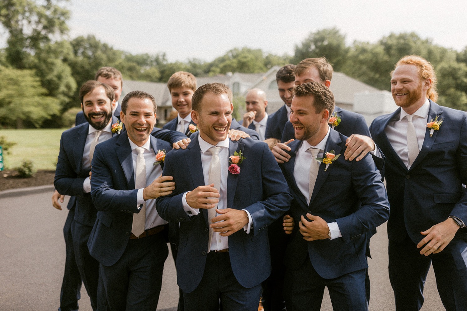 wedding party groomsmen navy suits laughing