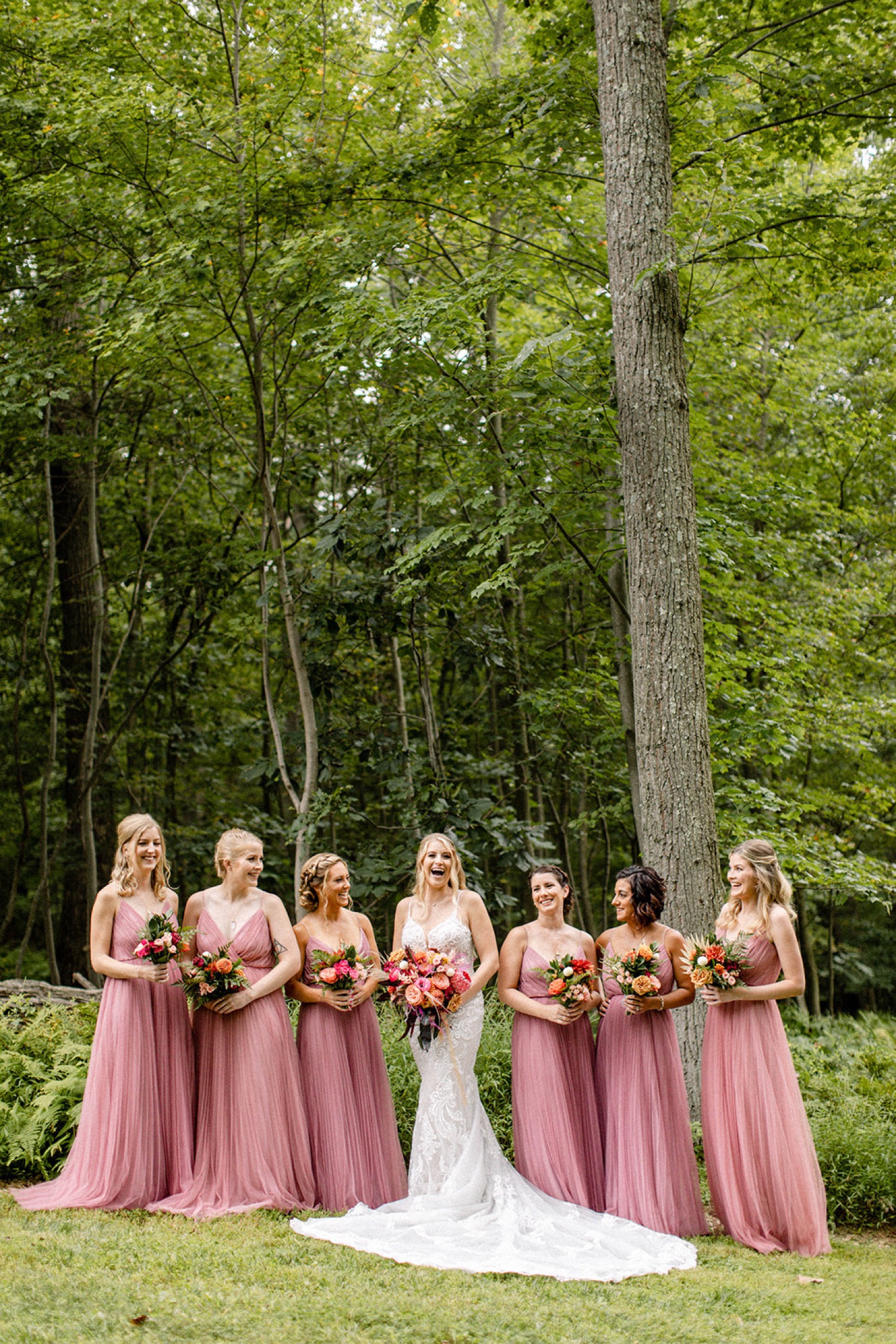 bridesmaids pink dresses colorful forest wedding