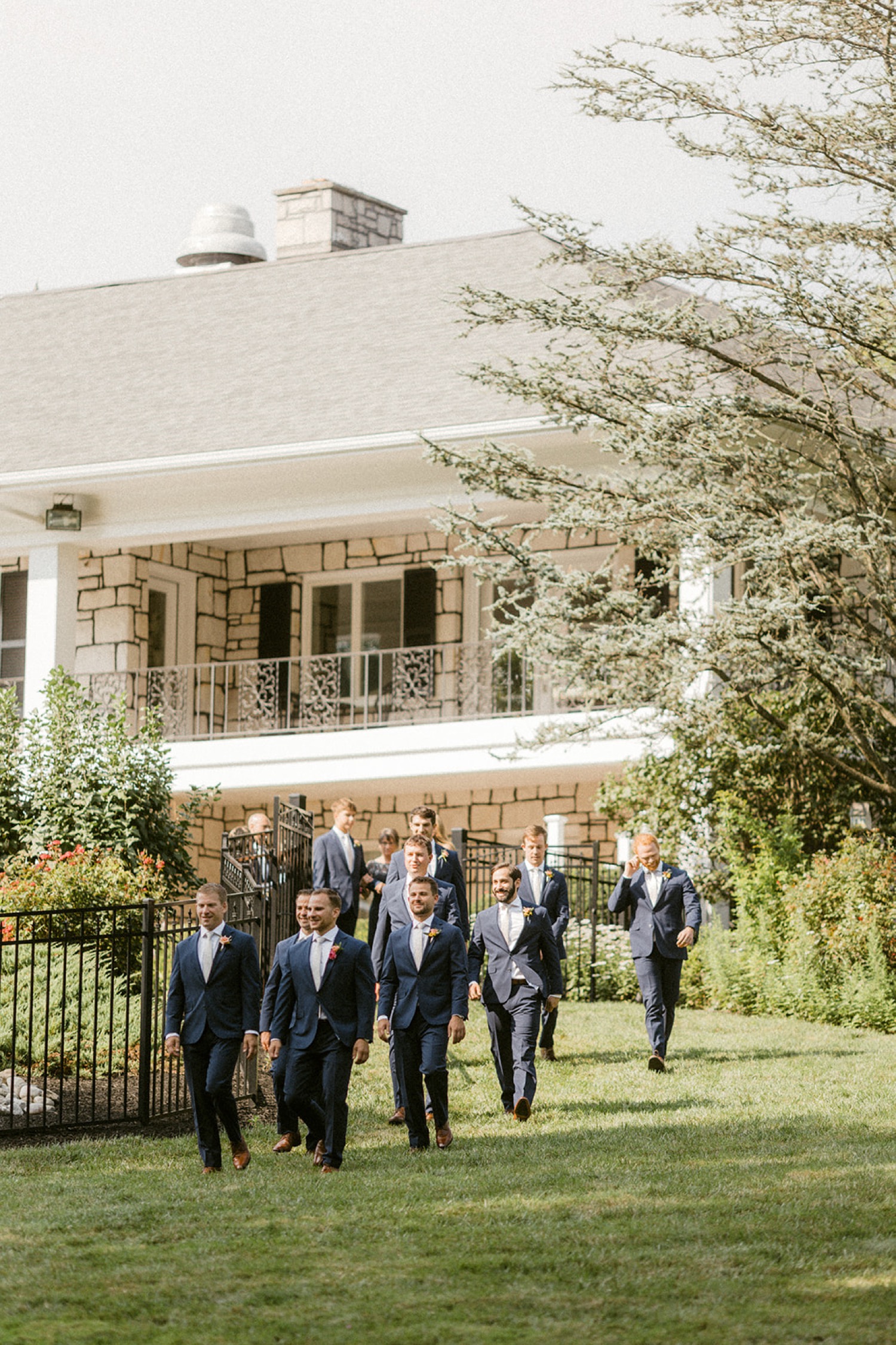 groomsmen walking into ceremony backyard wedding