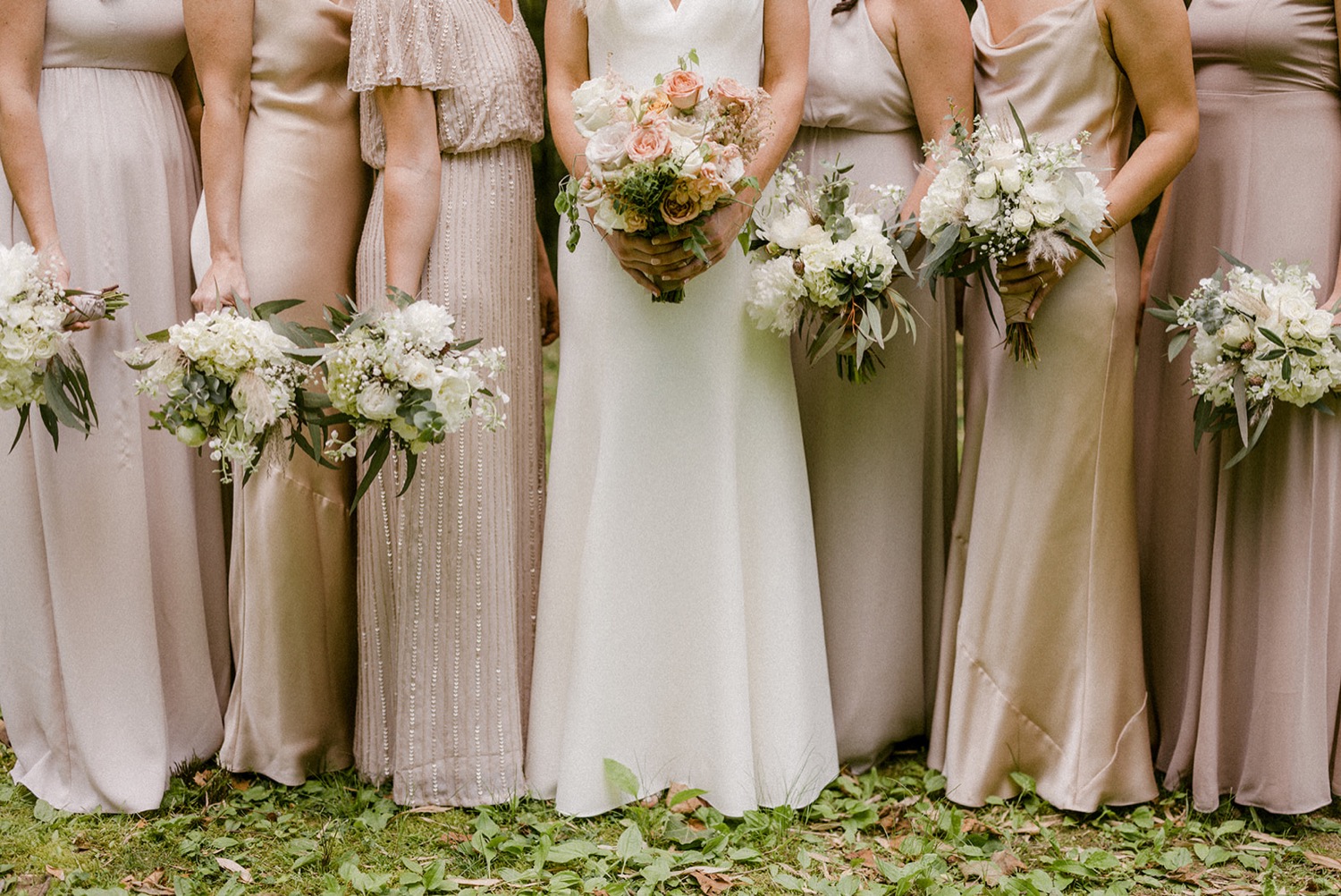 flower bouquets and champagne blush bridesmaids dresses