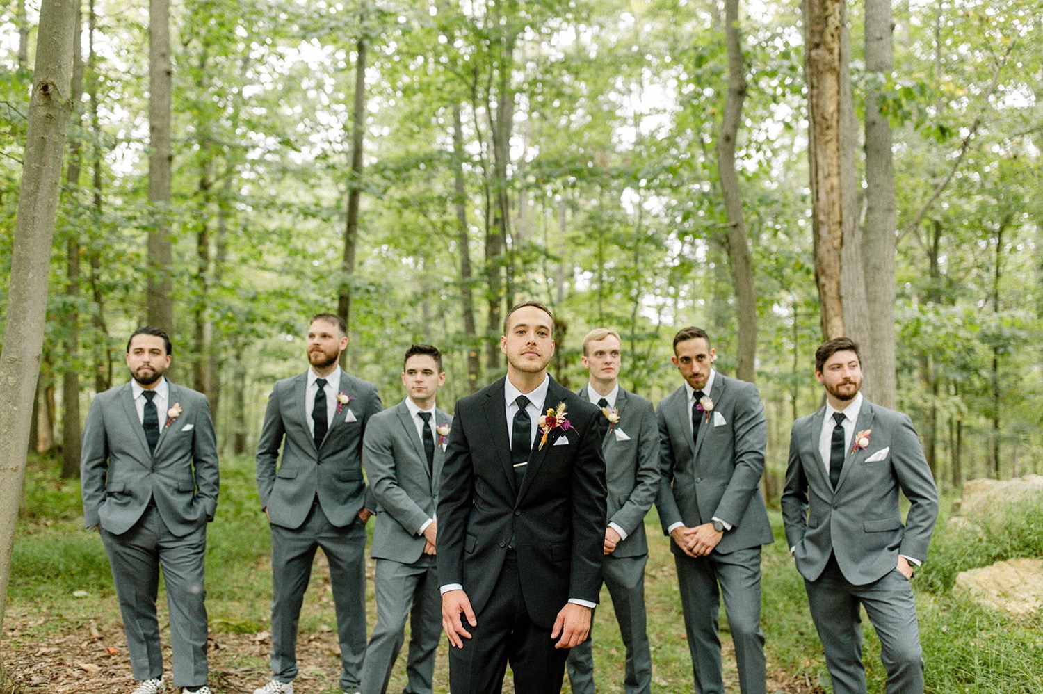 groom black suit and groomsmen grey suits