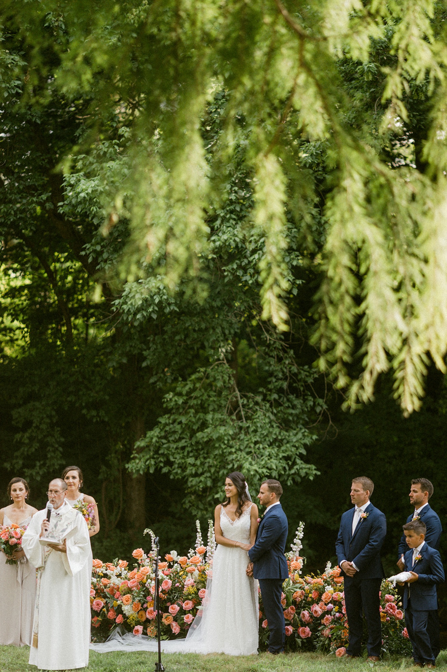 bride and groom holding hands during wedding ceremony dreamy backyard wedding