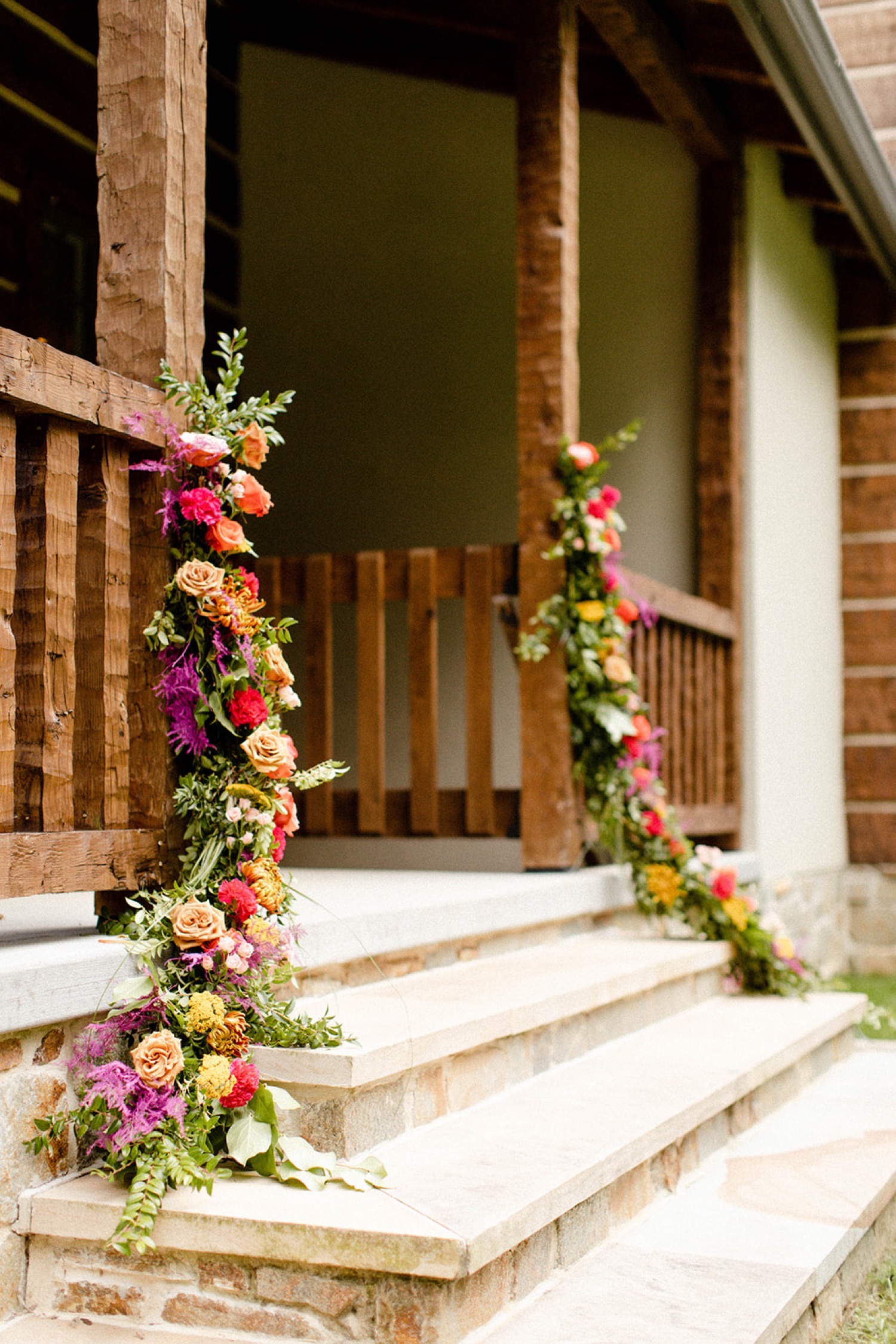 jewel tone flowers around door colorful bohemian backyard wedding