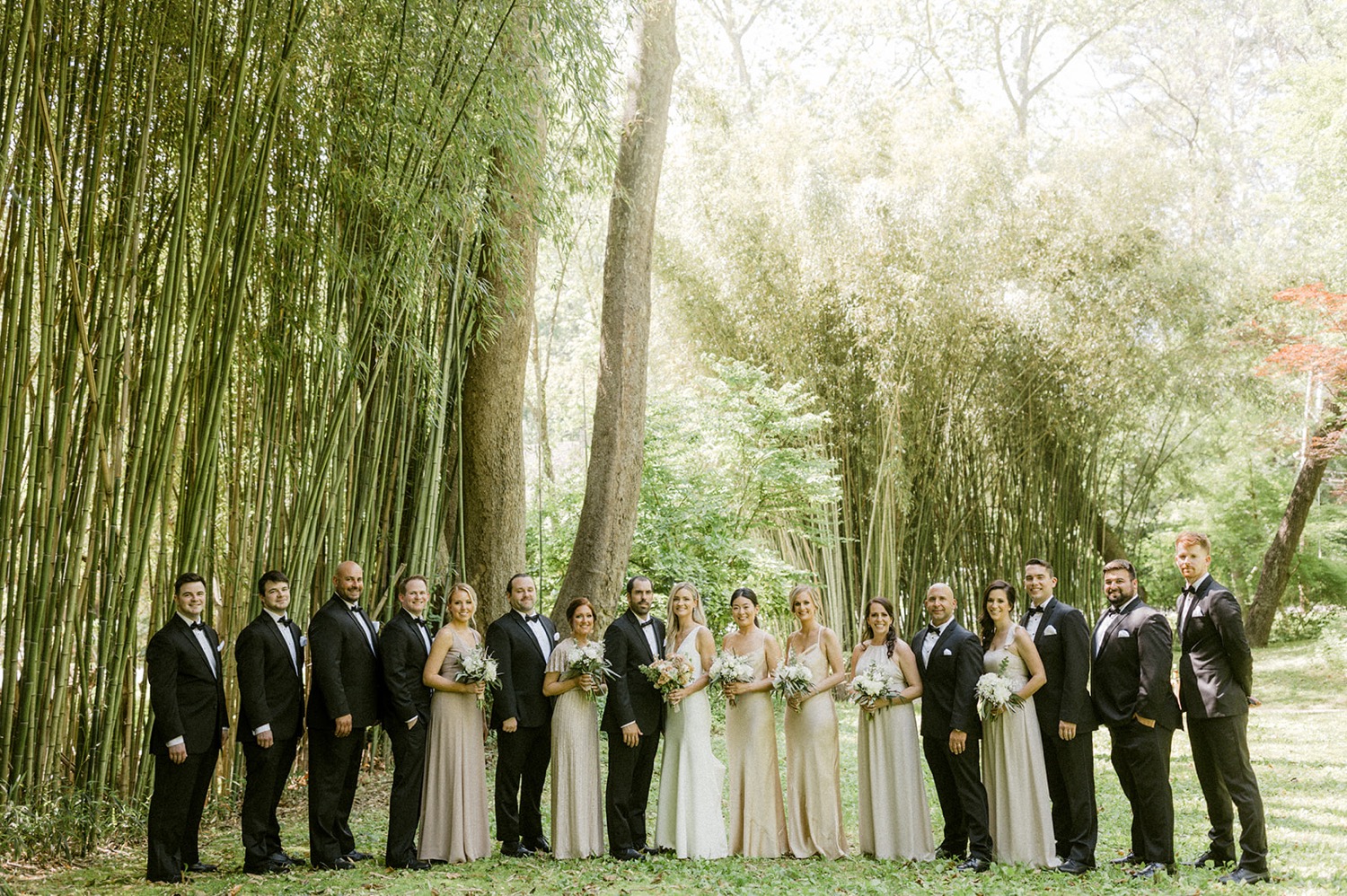 wedding party photos in front of tall bamboo the old mill