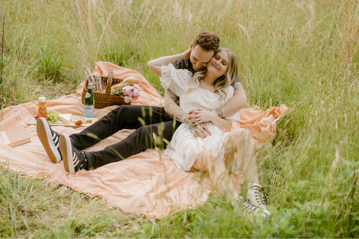 couple cuddling on blanket bohemian engagement session