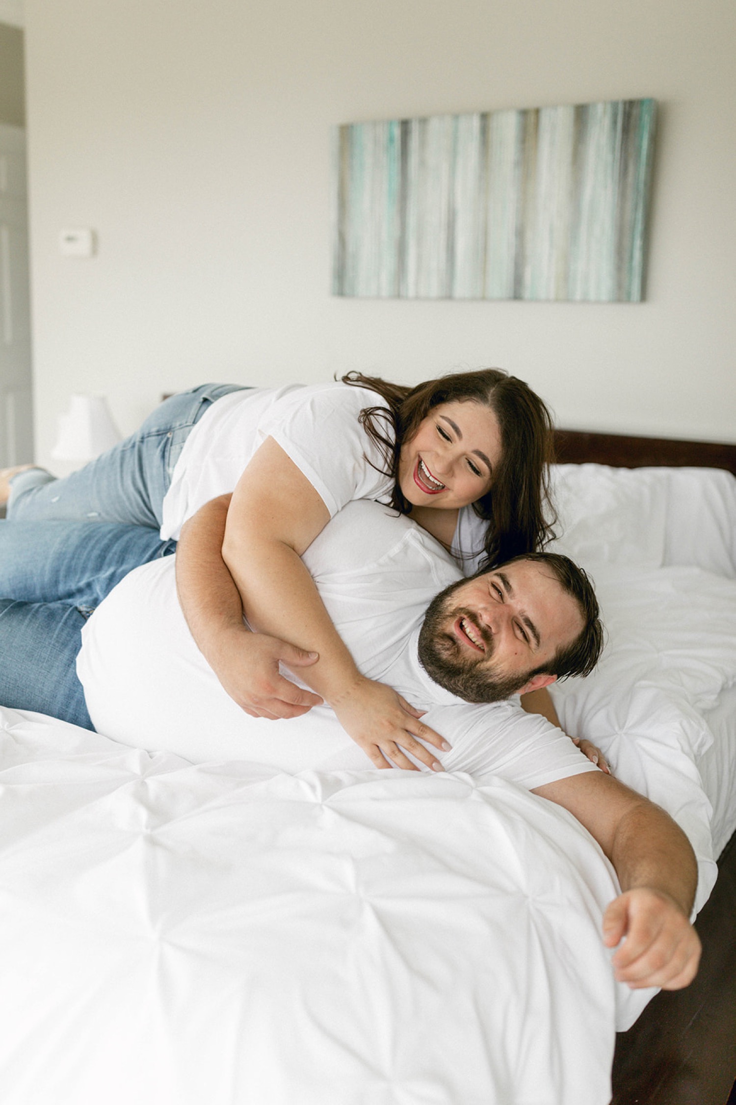 playful engagement session in bed