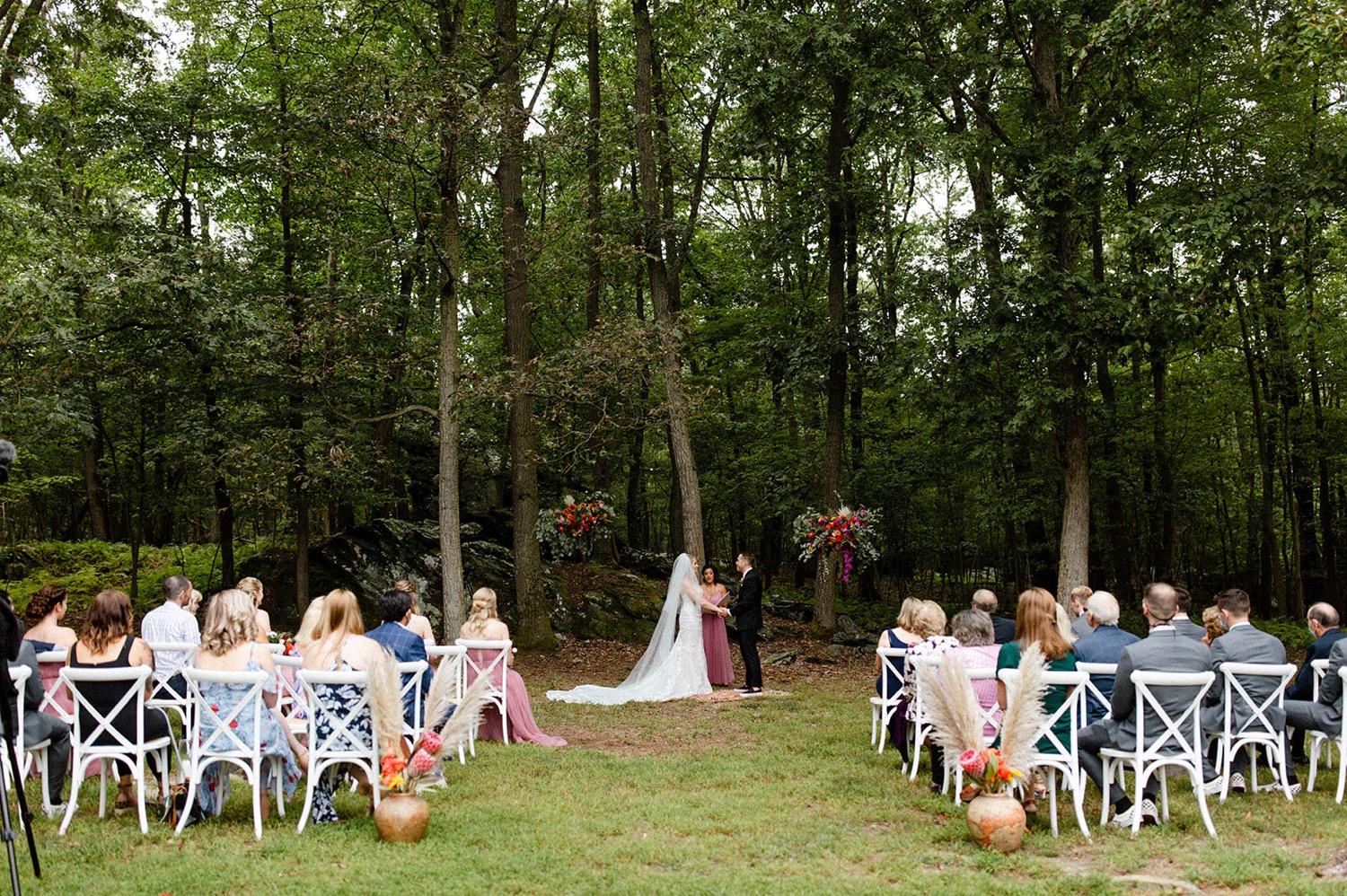 bride and groom holding hands during backyard micro wedding