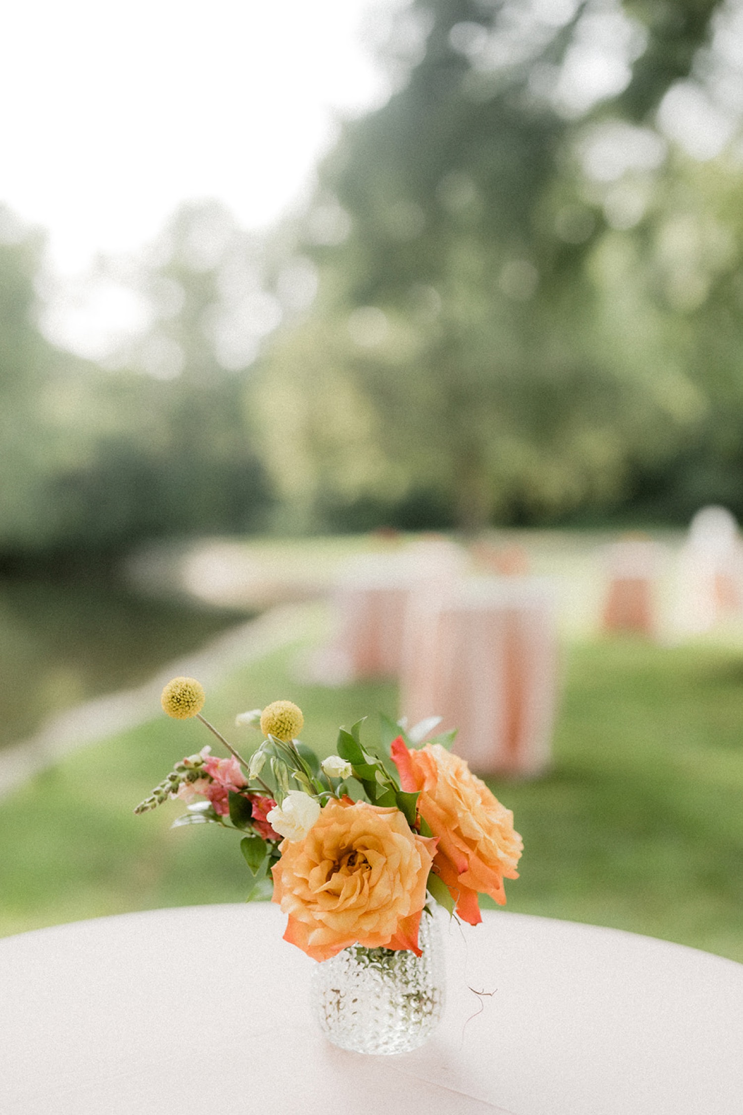 orange flowers cocktail hour table centerpiece dreamy backyard wedding