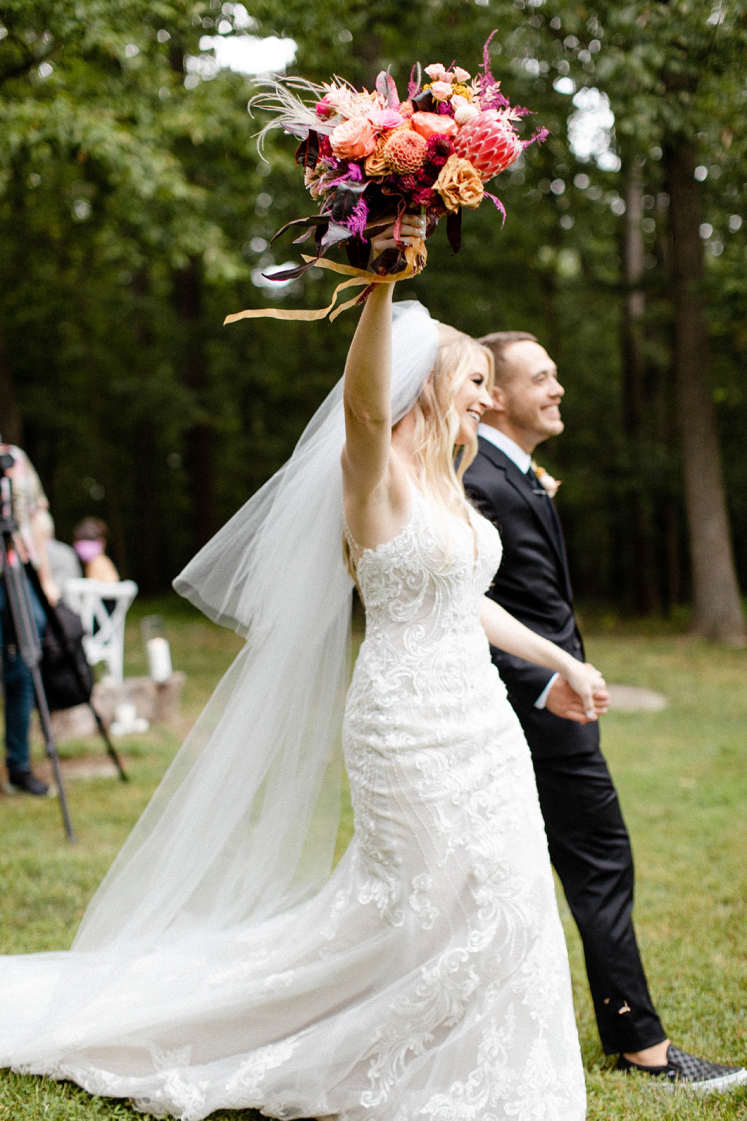 bride arm raise cheering walking out of wedding ceremony