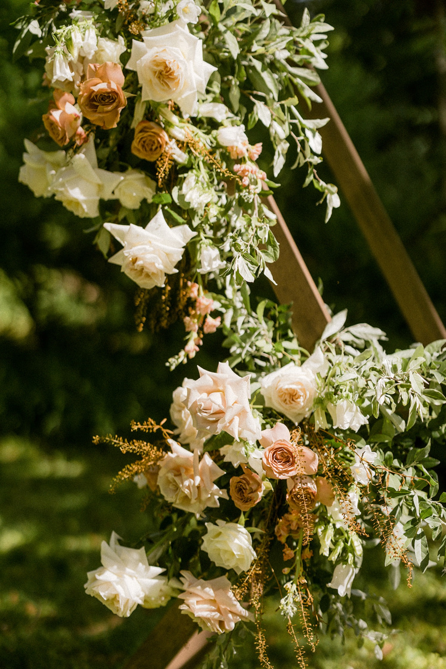 champagne neutral blush flowers on wedding arbor the old mill