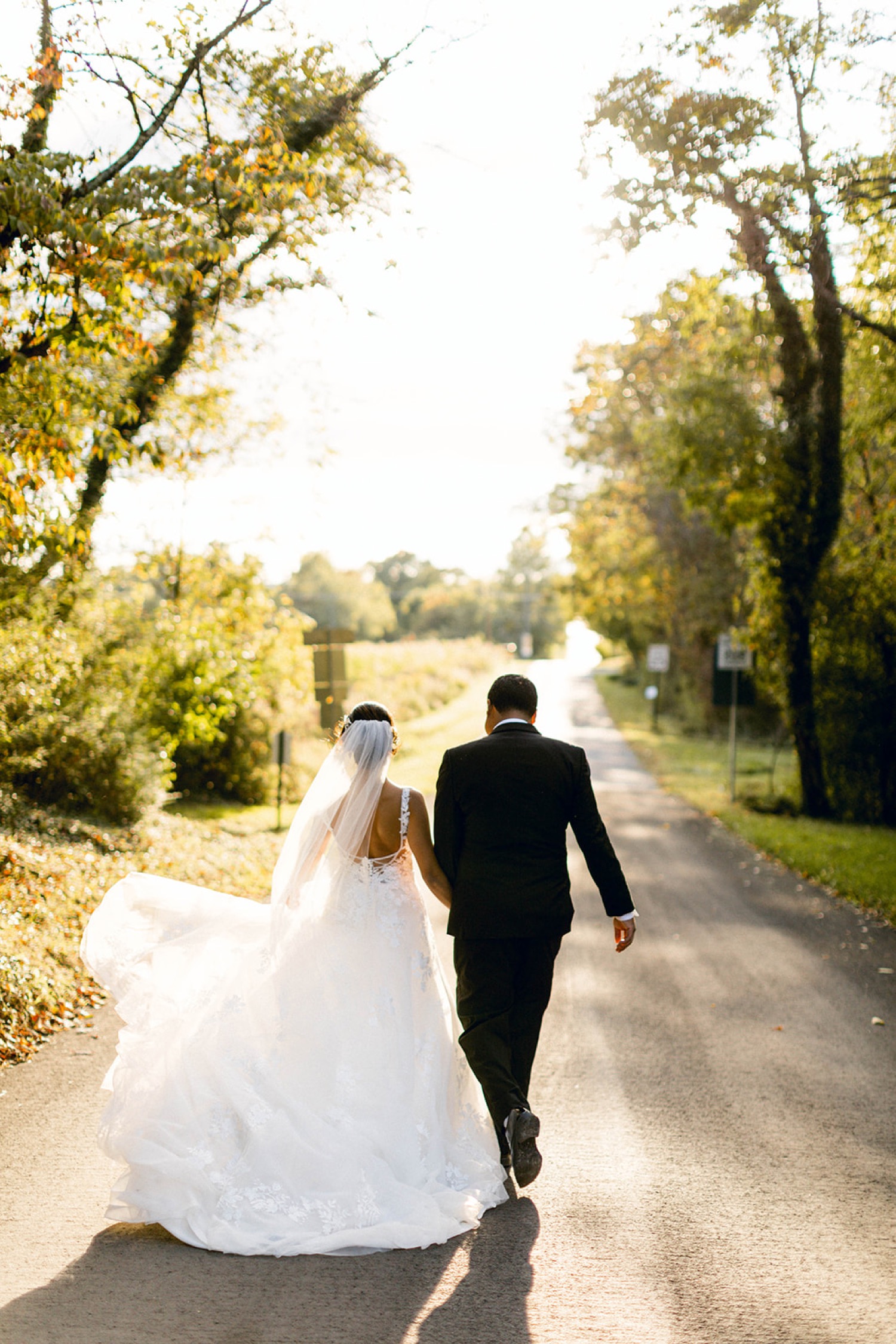 bride and groom walking on road fairytale wedding at historic shady lane