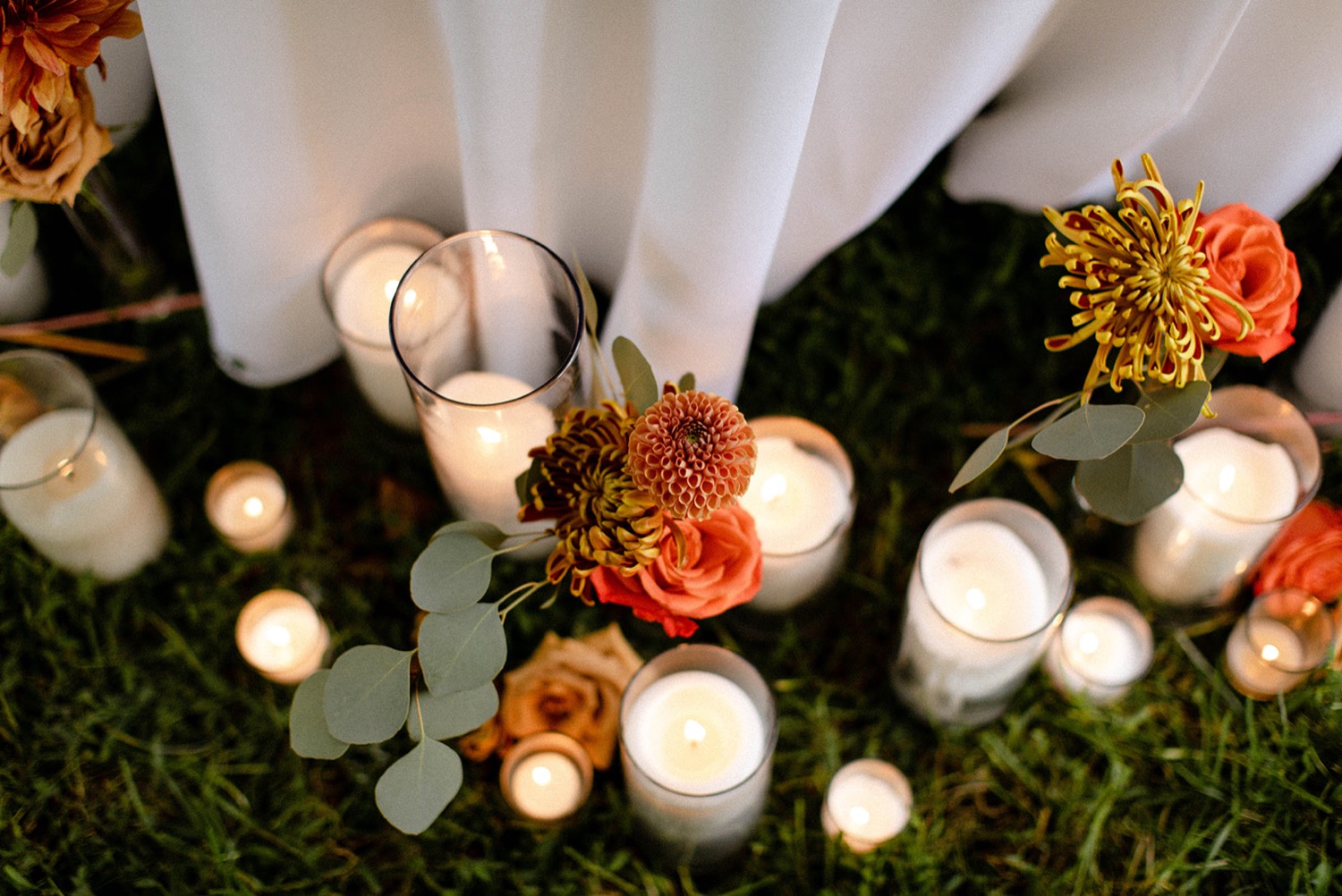 candles and orange flowers reception decor colorful bohemian wedding