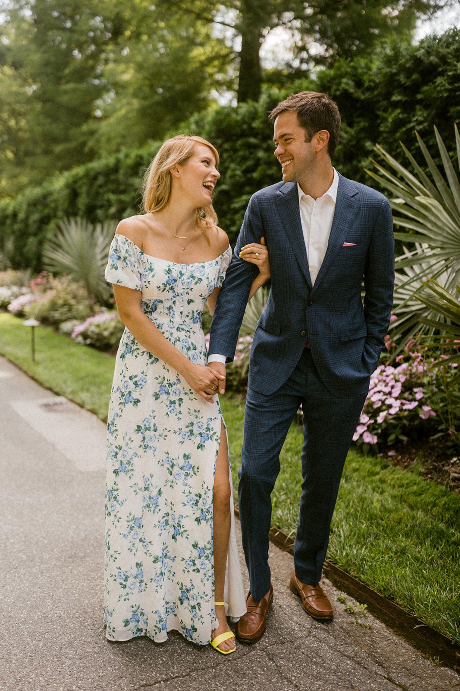 longwood gardens engagement session formal couple holding hands laughing