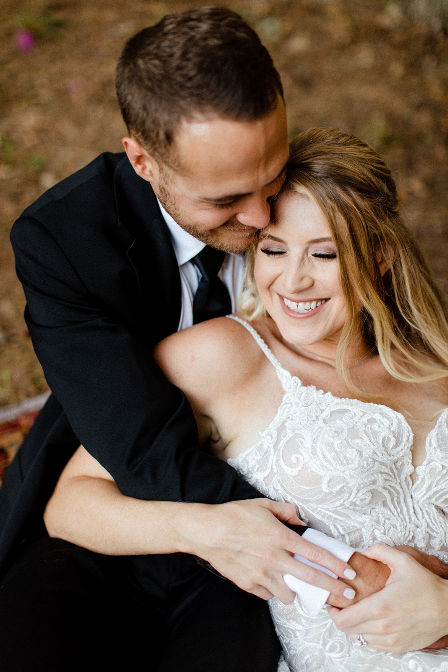 close up couples portraits bride and groom laughing