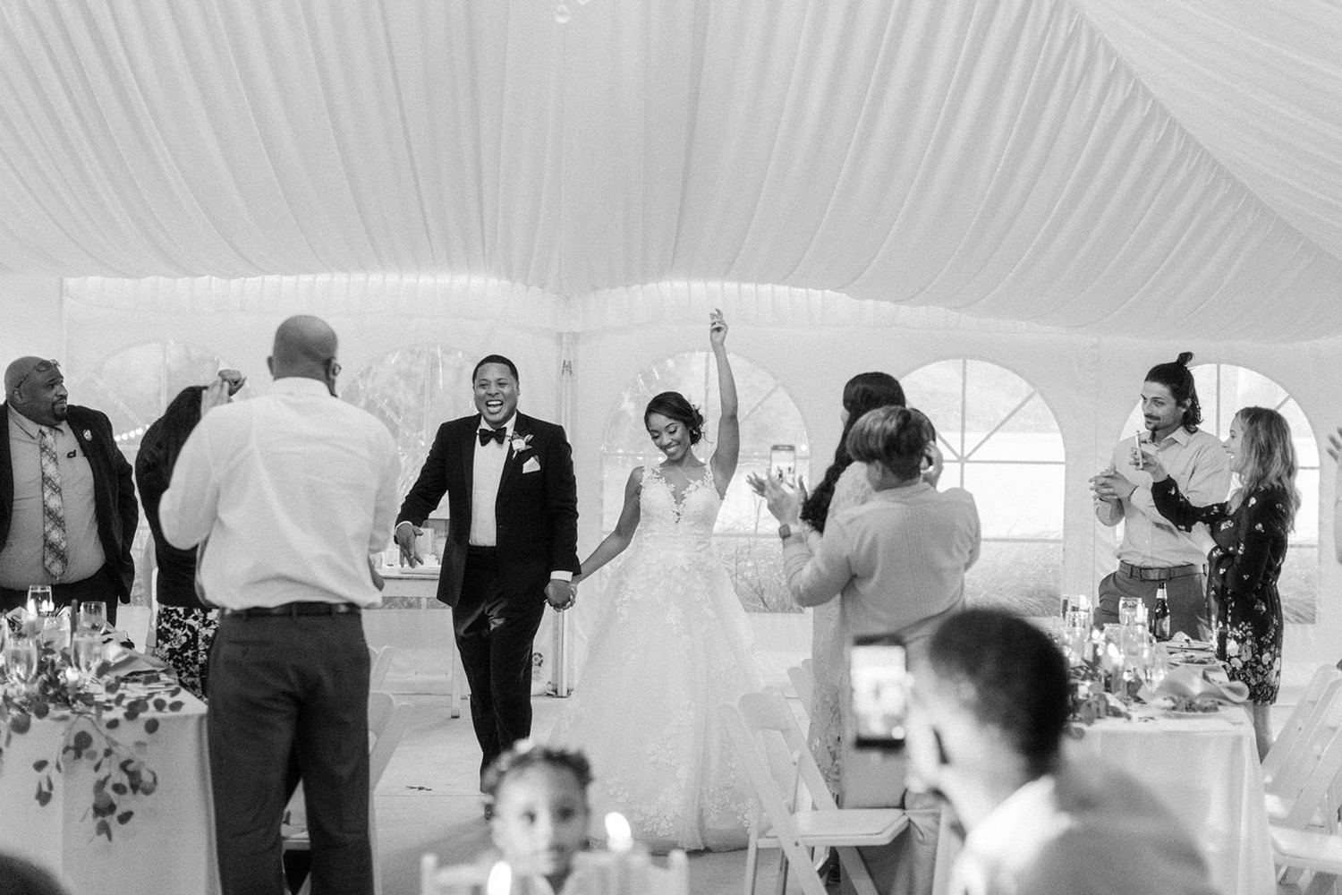 bride and groom entering wedding reception tent