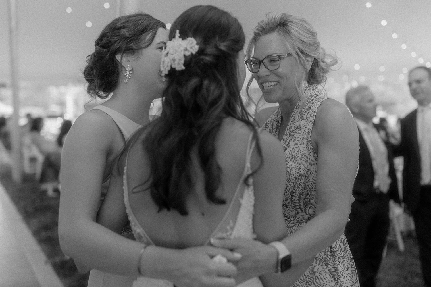 bride hugging wedding guests at reception