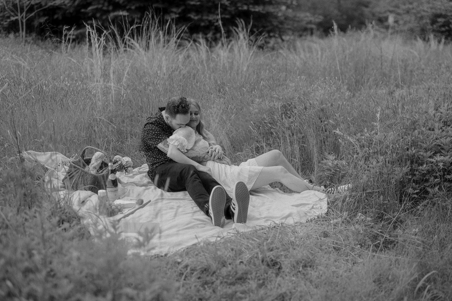 couple hugging picnic bohemian engagement session