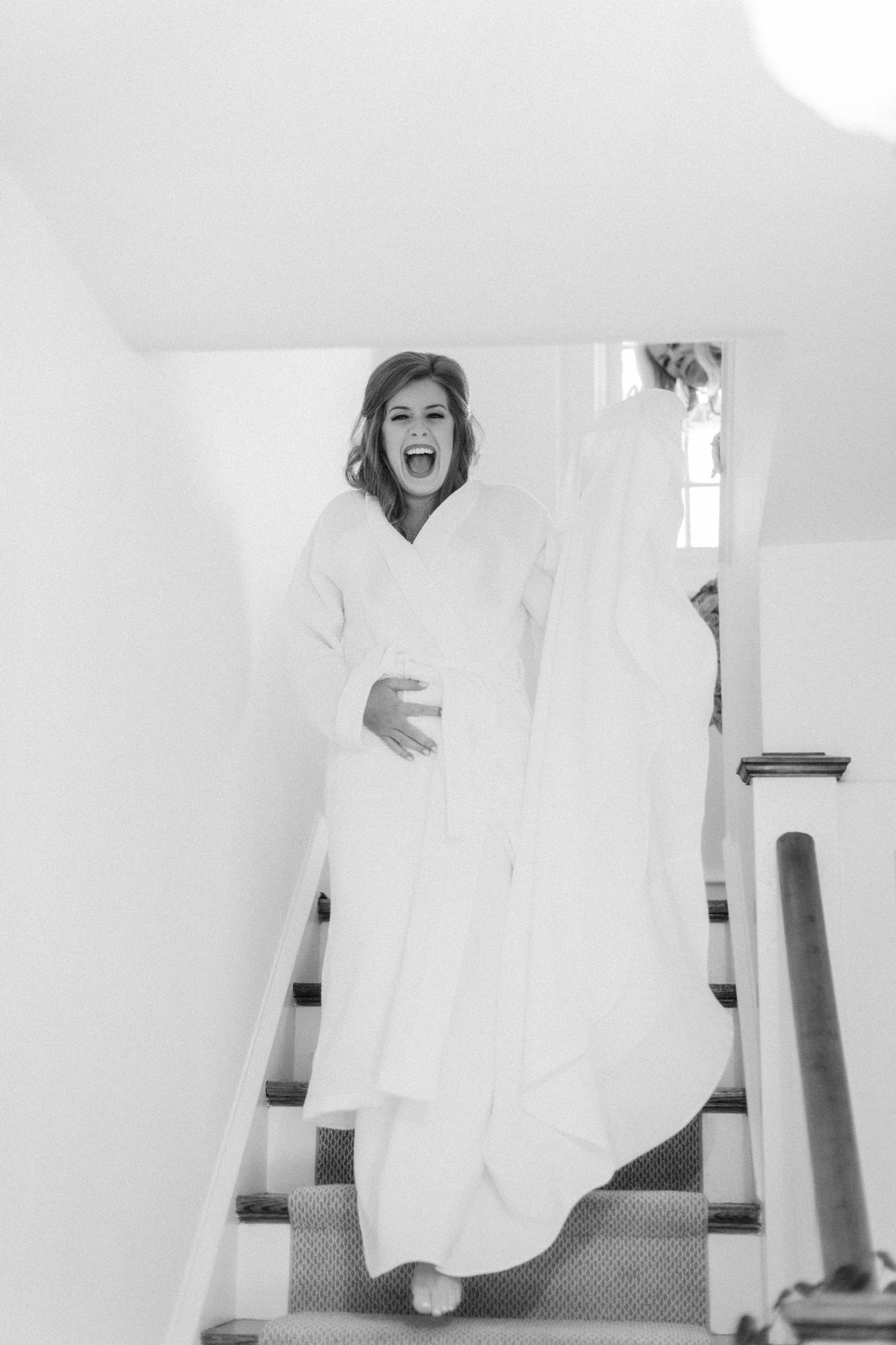 bride walking down stairs in robe