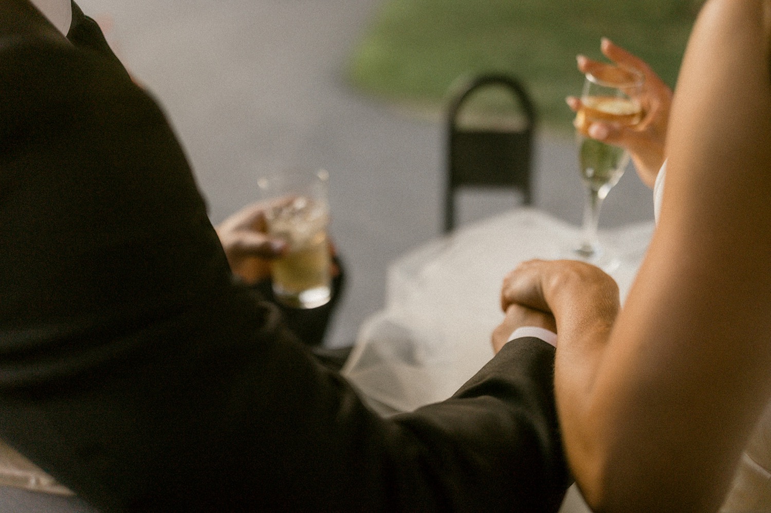 couple holding champagne glasses holding hands