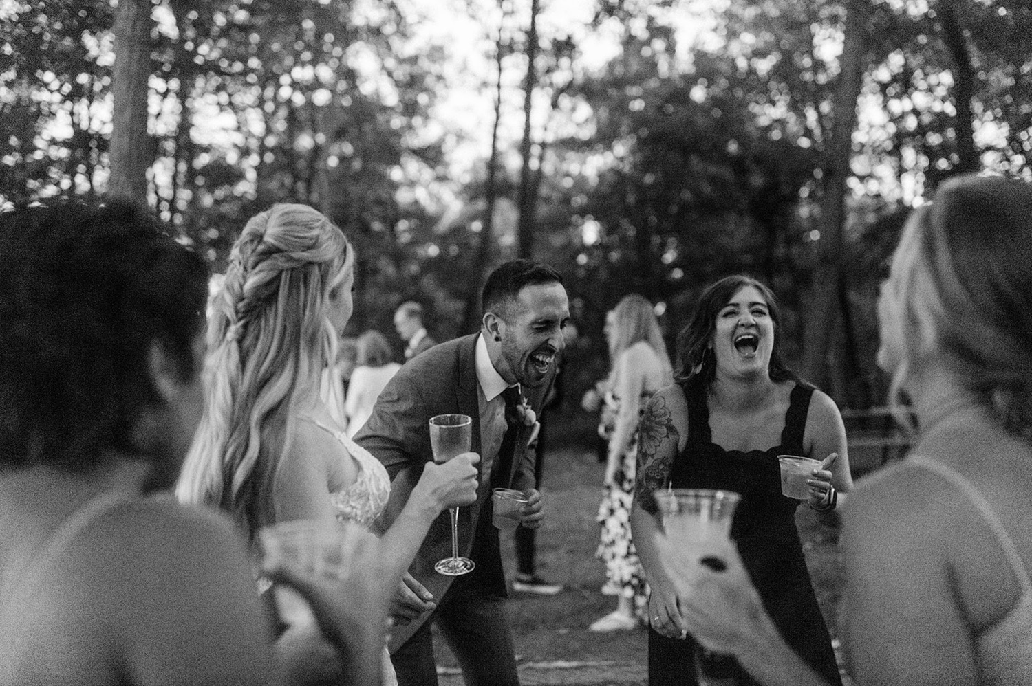 guests laughing in backyard micro wedding