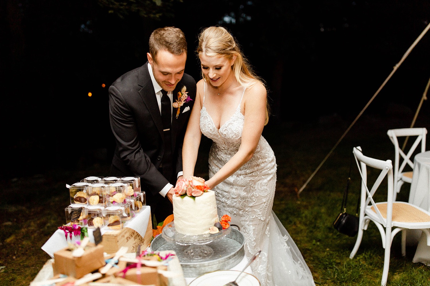 bride and groom cutting cake colorful bohemian wedding
