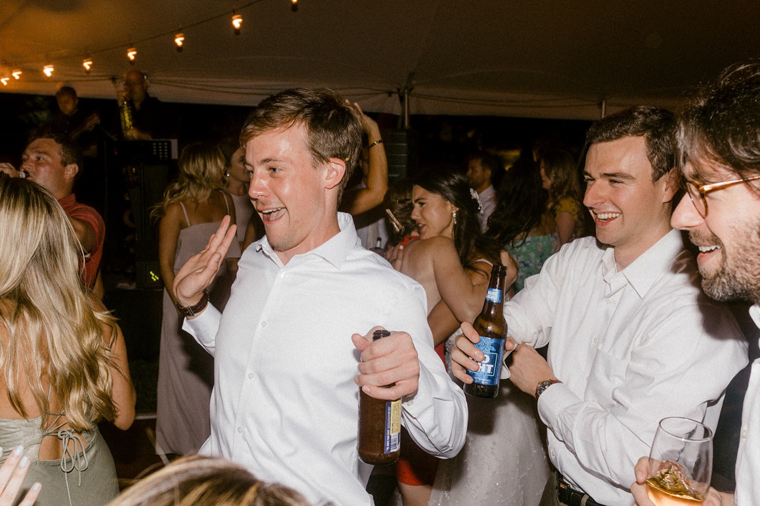wedding guests dancing laughing at reception