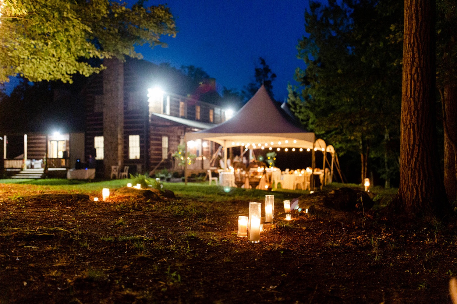 candlelit walkway to tent backyard micro wedding
