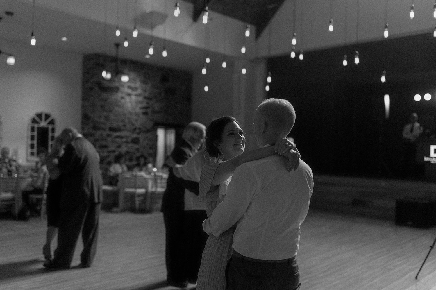 couple slow dancing under lights wedding reception the old mill philadelphia