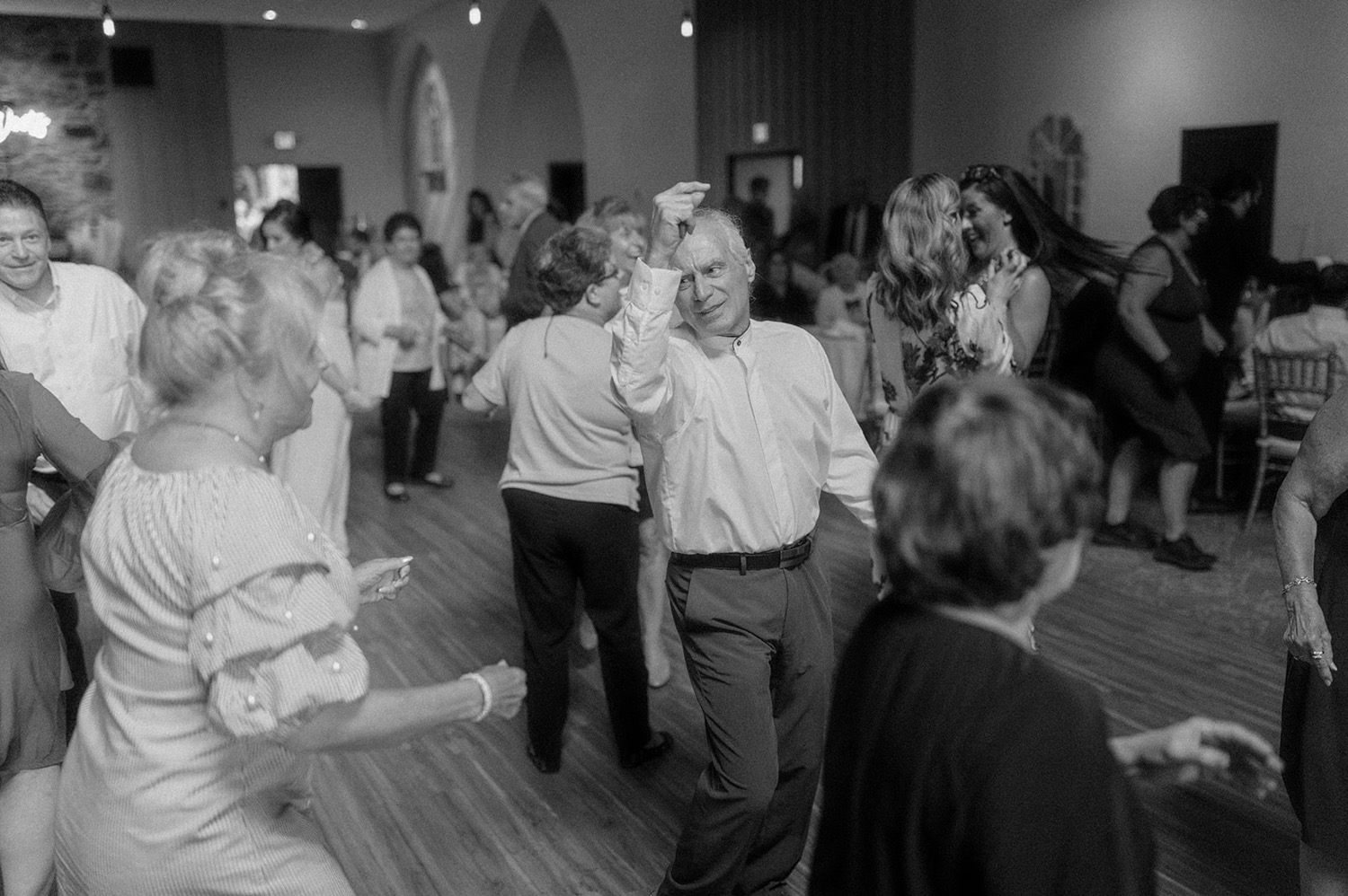 guests dancing at wedding reception black and white