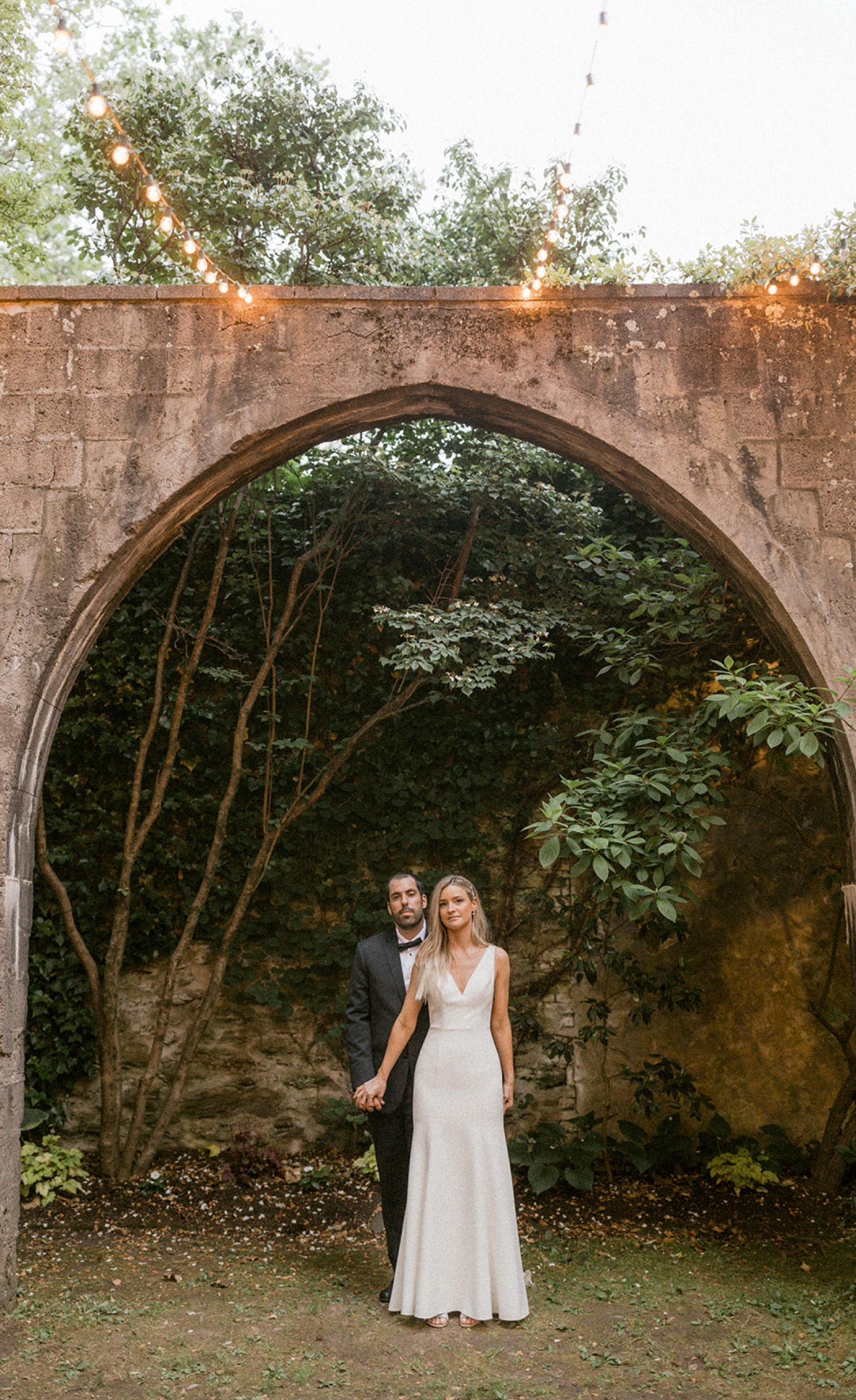 couple holding hands under arch the old mill philadelphia
