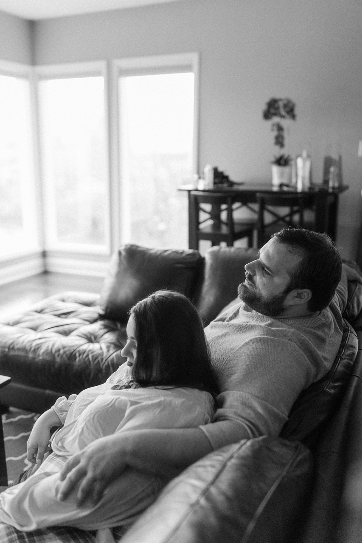 couple cuddling on couch engagement session