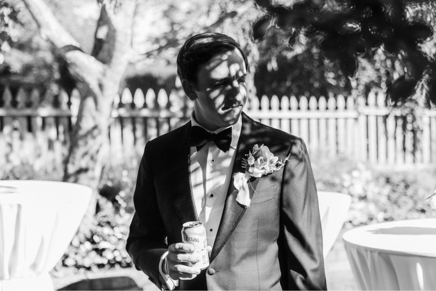 groom holding beer luxurious backyard wedding