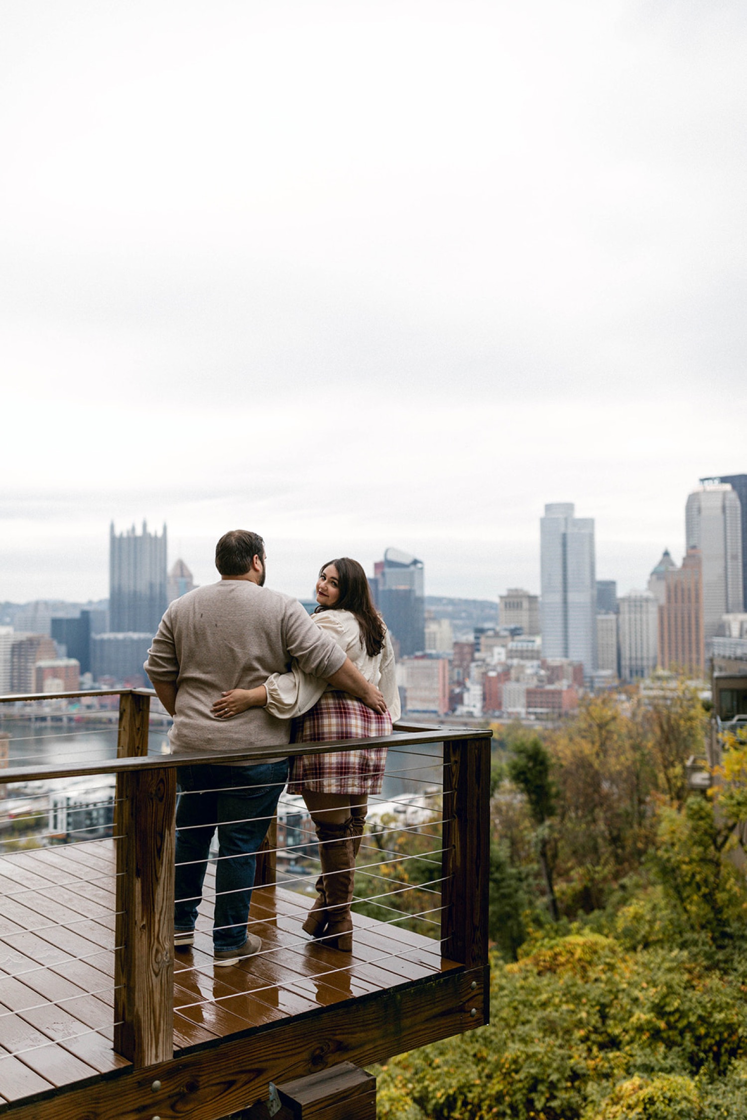 pittsburgh skyline couple hugging engagement session