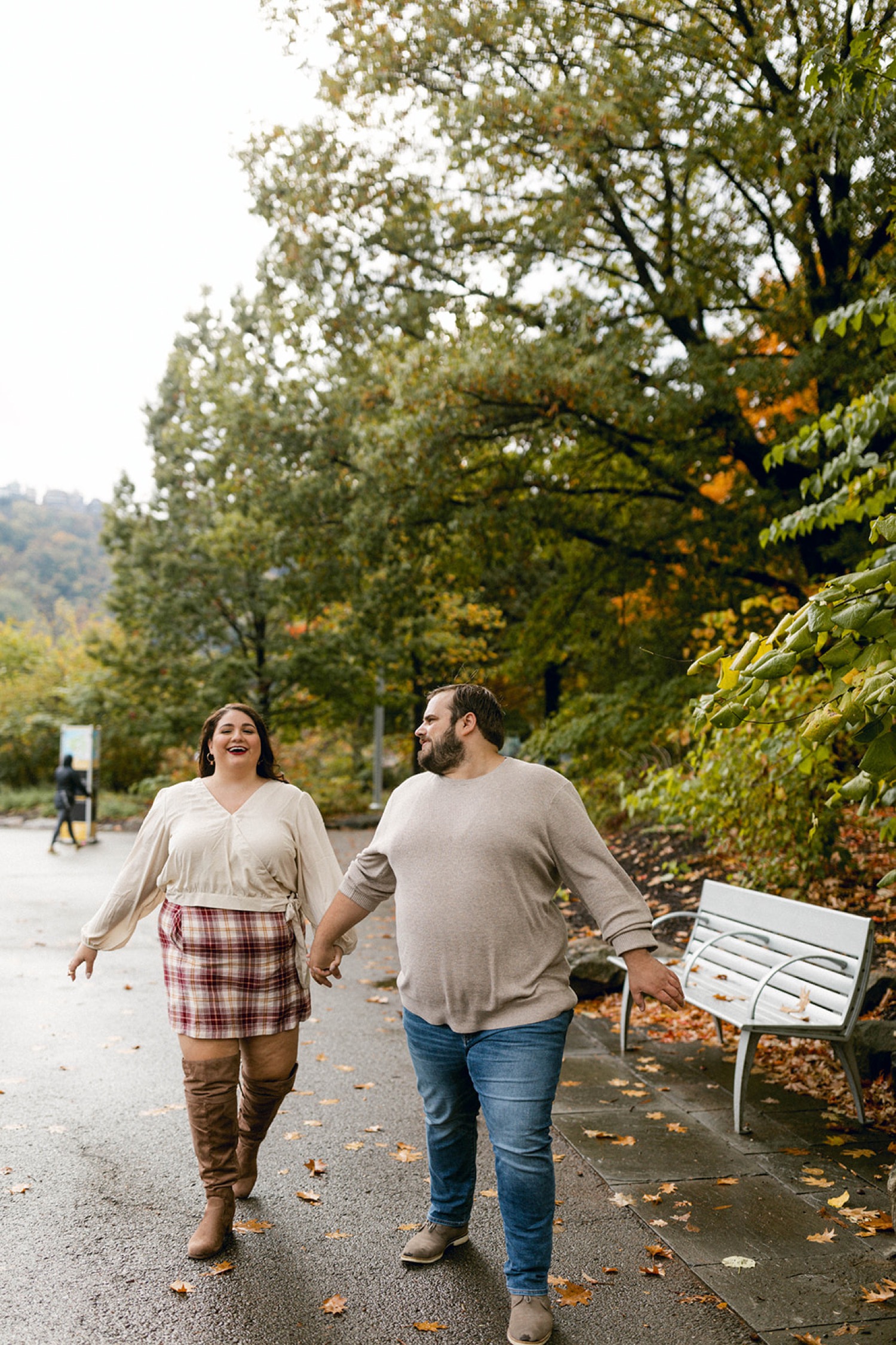 couple holding hands walking engagement session