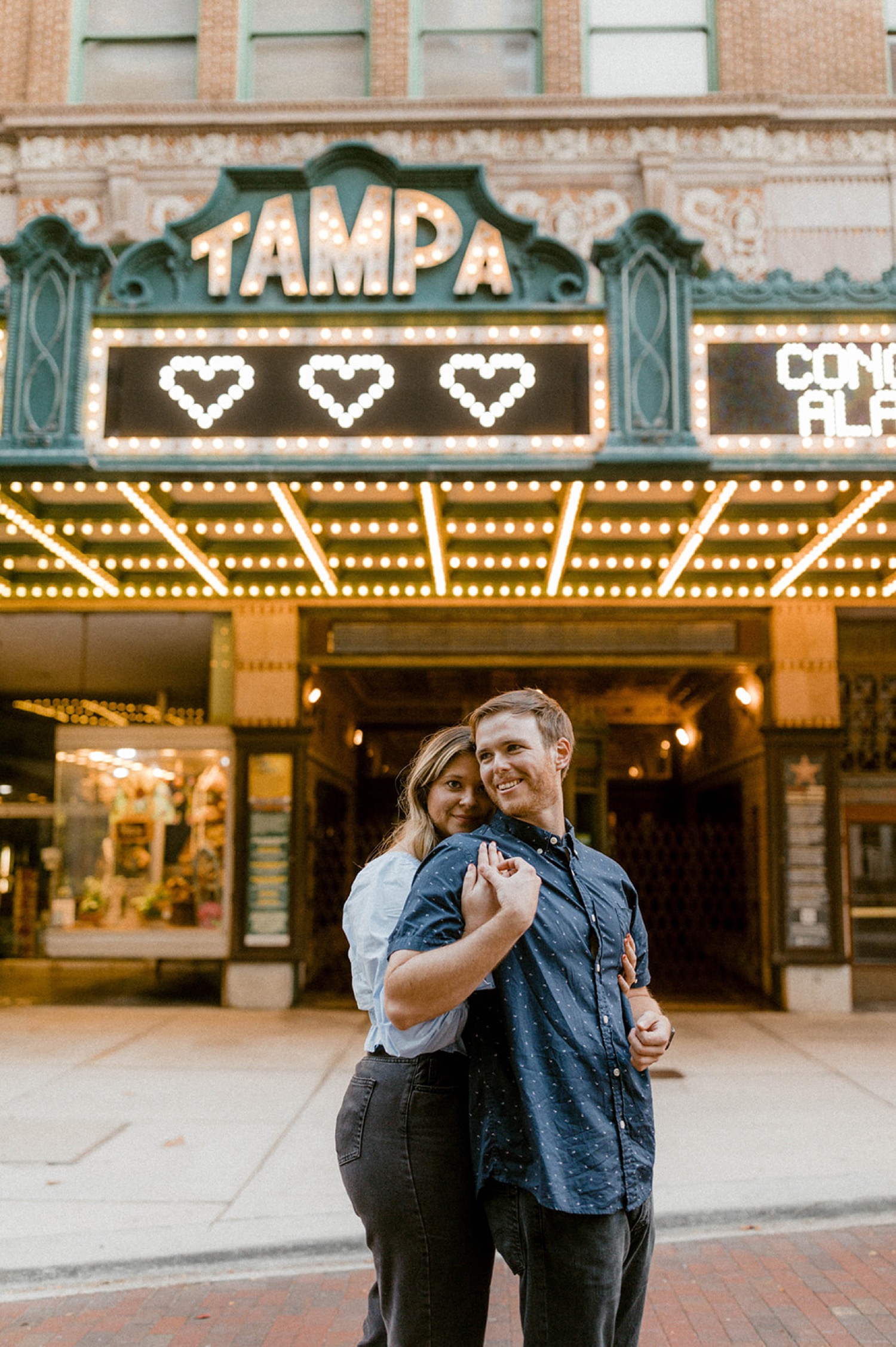 couple hugging in front of tampa theater