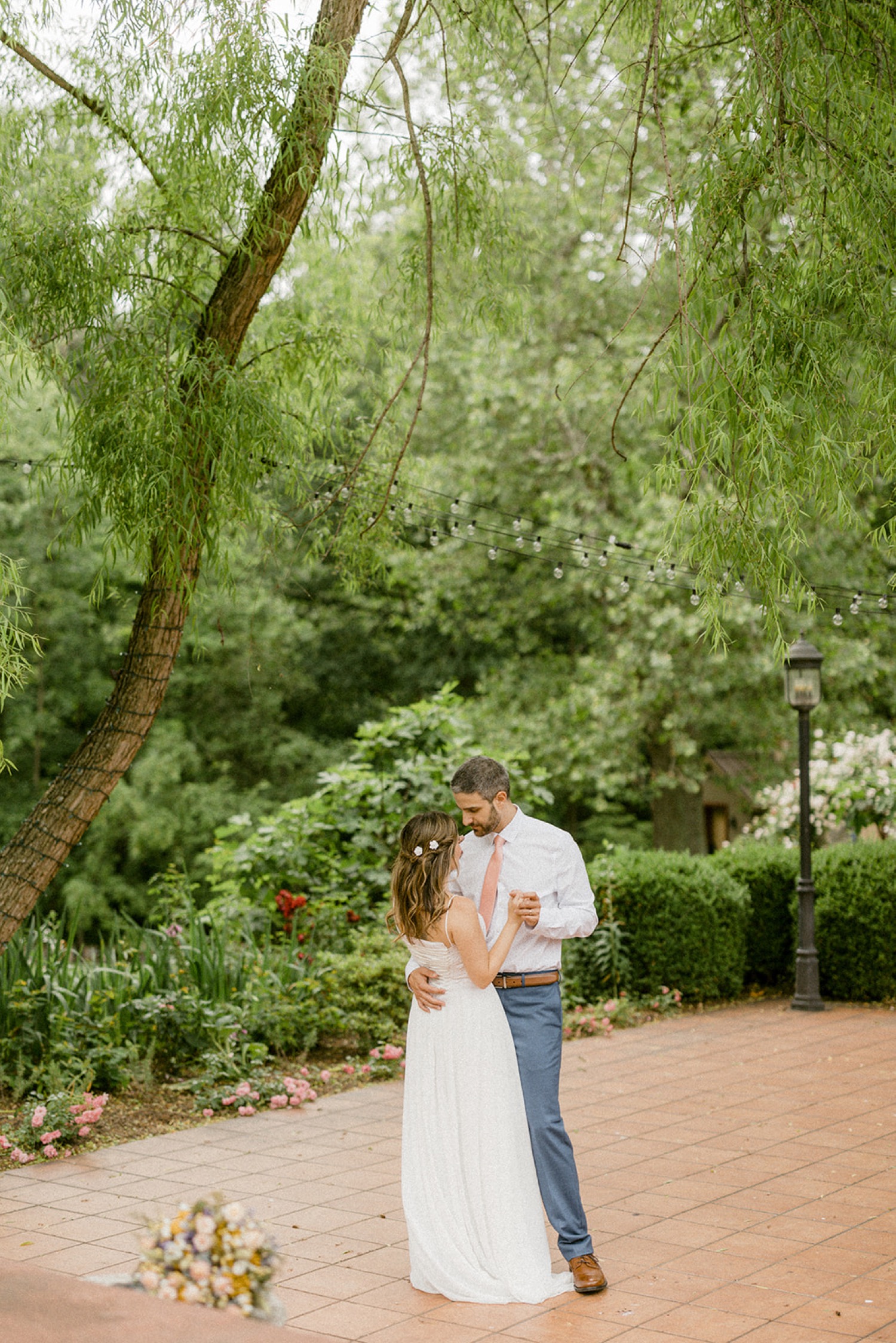 couple dancing under trees whimsical wedding session