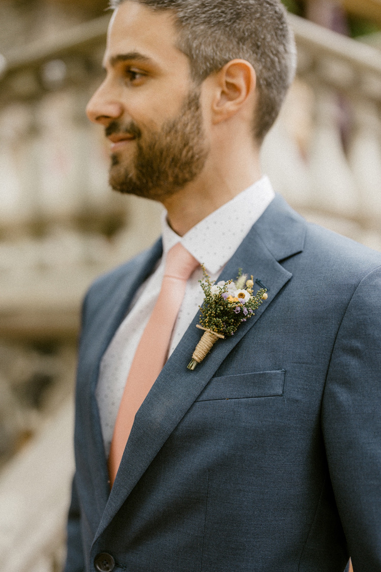 groom blue suit pink tie dried flowers