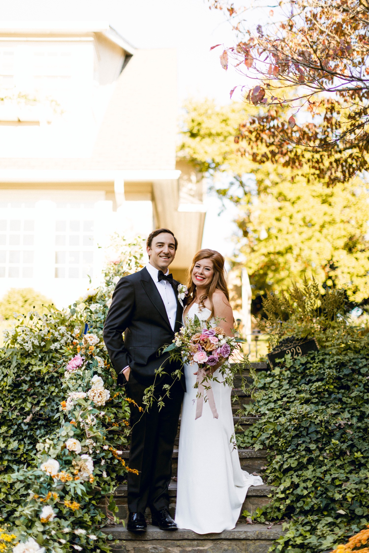 bride and groom couples portrait in front of house luxurious backyard wedding