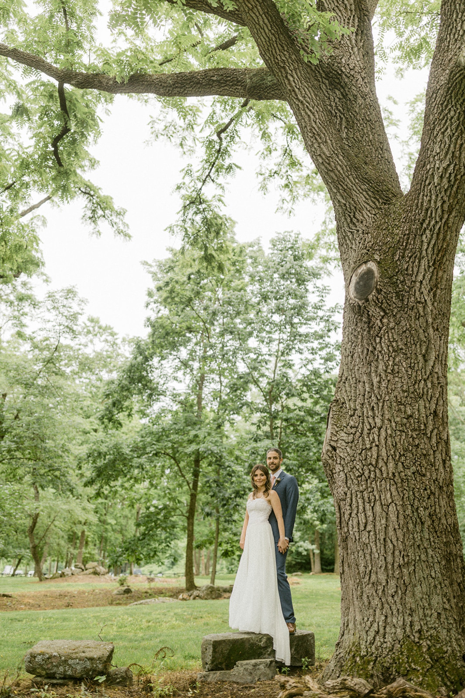couple standing under tree moonstone manor wedding session