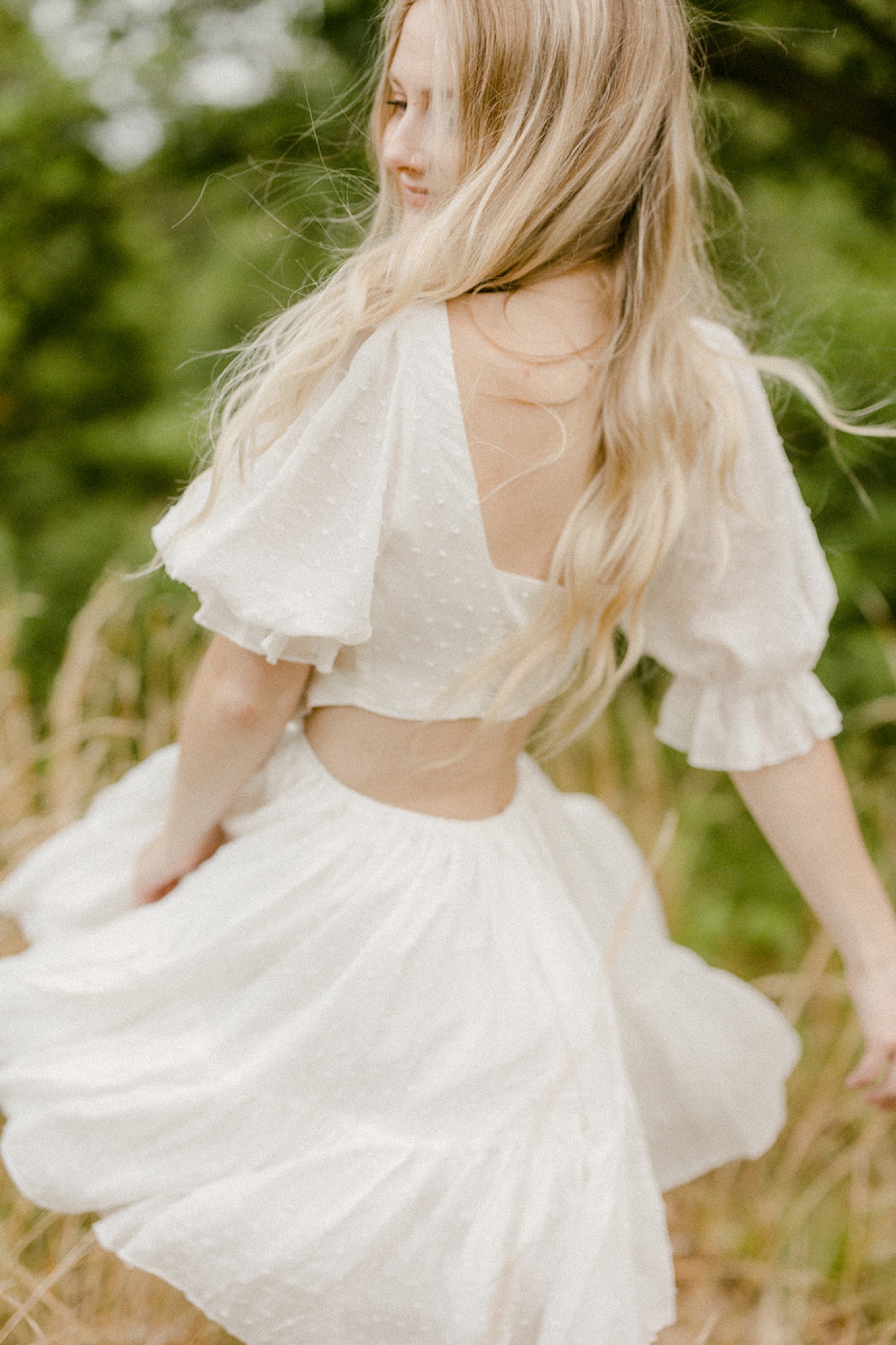 girl twirling in field boho chic white dress andorra meadows